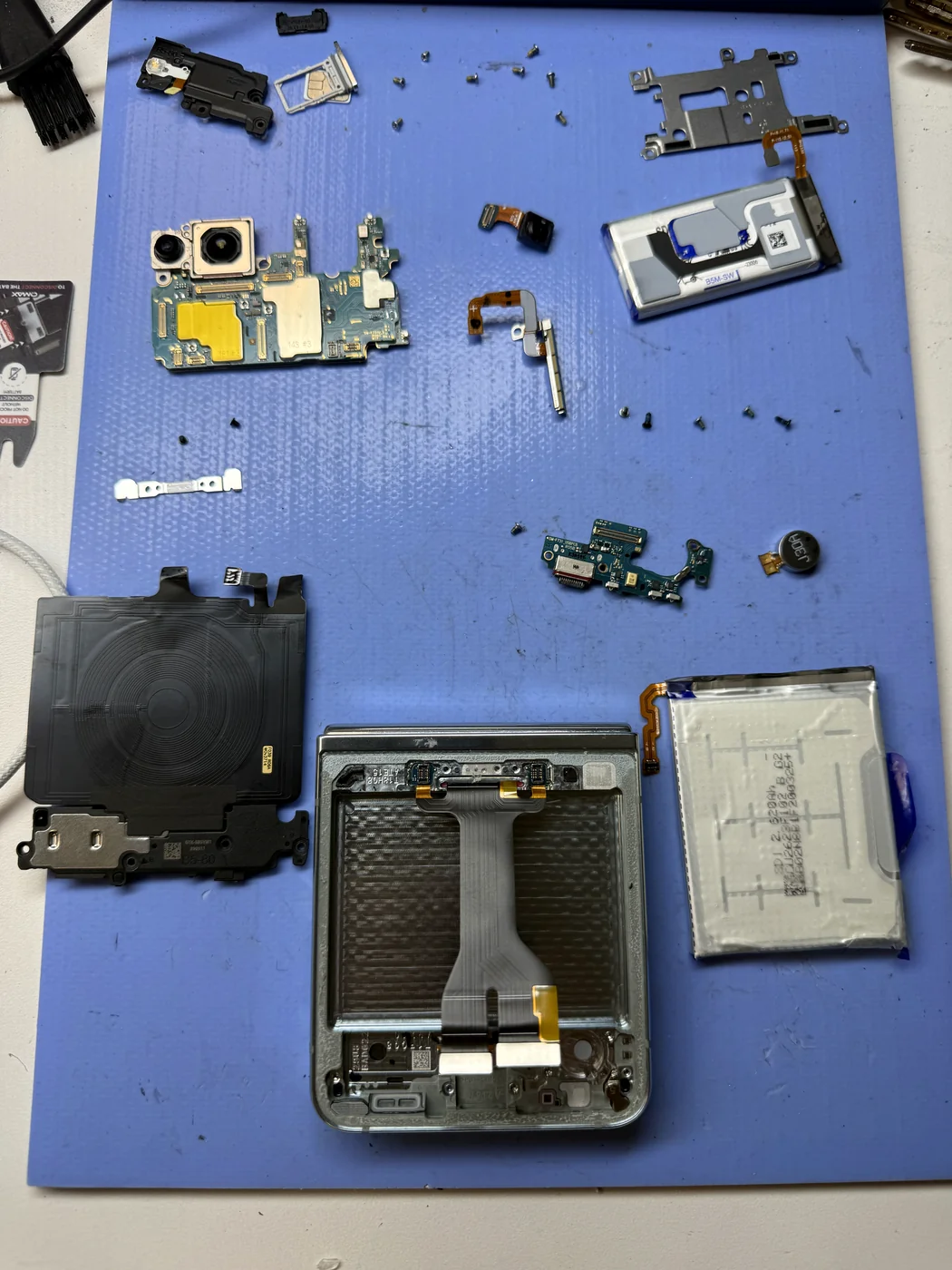 Original parts transferred from broken Galaxy Z Flip screen to the new screen assembly at FIXSTORY DTLA