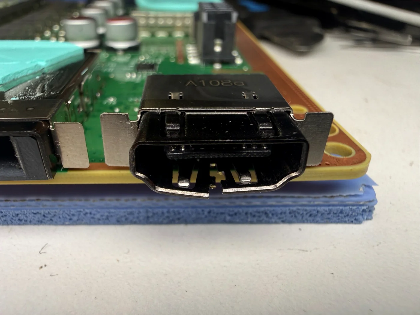 New HDMI port soldered onto the Xbox Series X mainboard, shield legs anchored