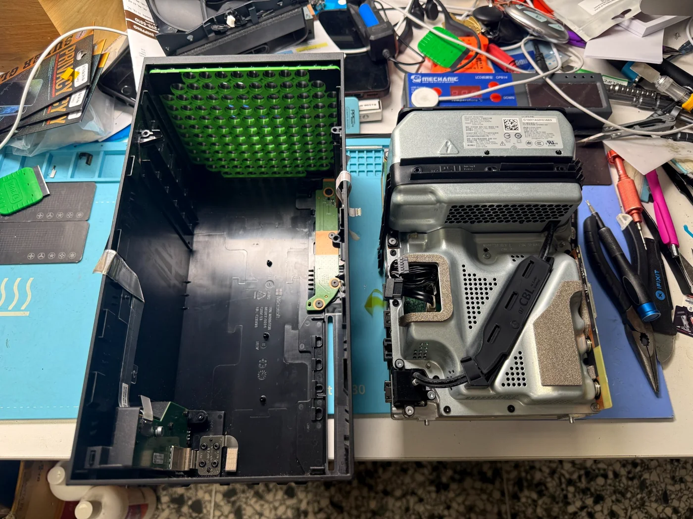 Xbox Series X outer shell removed, the internal chassis and power supply beside it