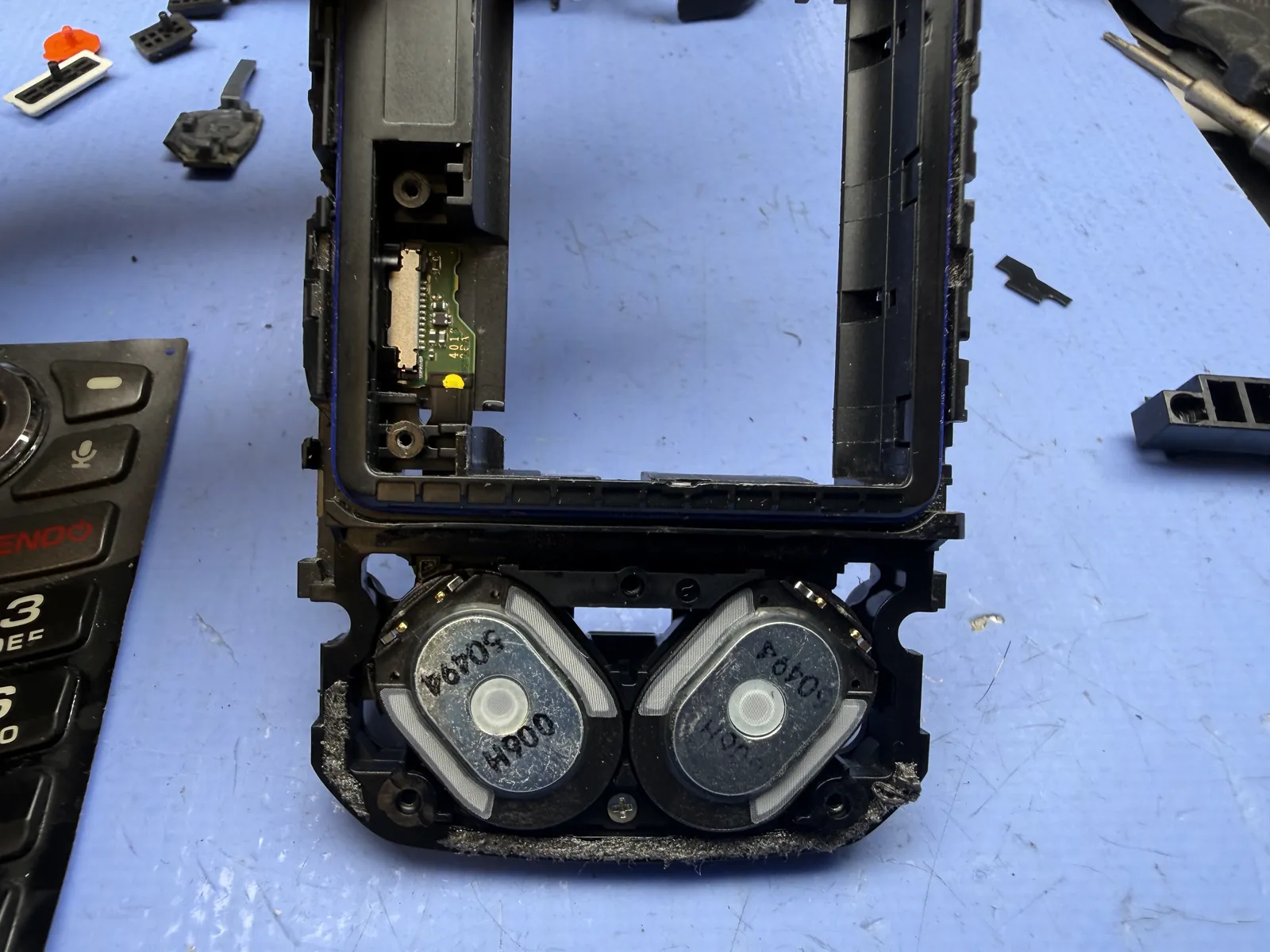 Charging port board inside the Kyocera DuraXA E4831 housing next to the speakers