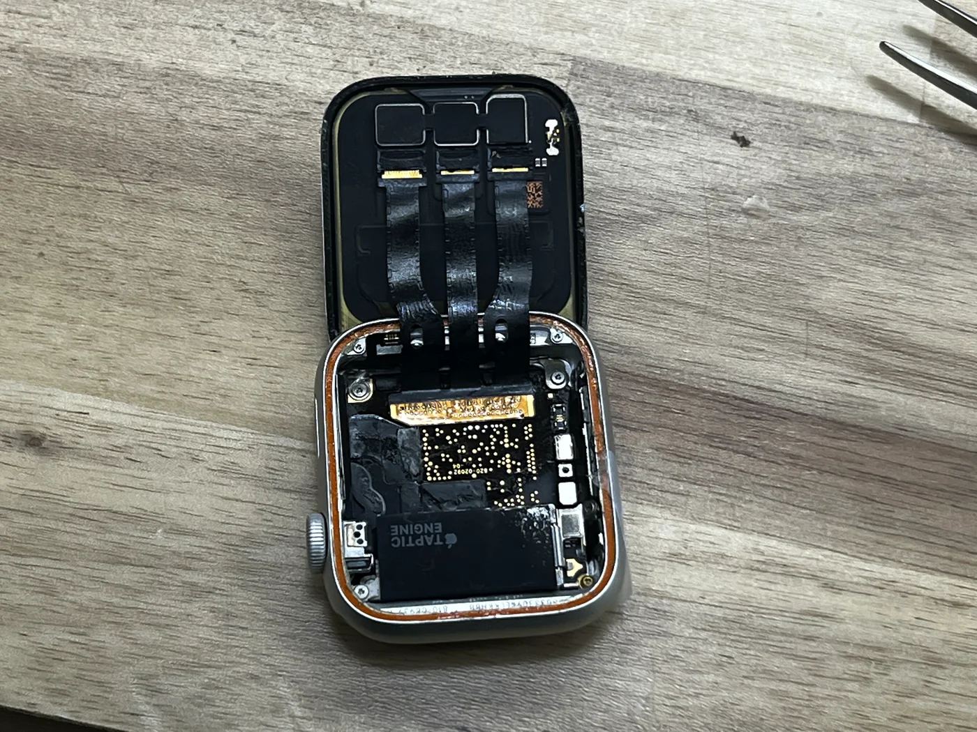 New replacement screen connected to the repaired Apple Watch Series 5 before sealing