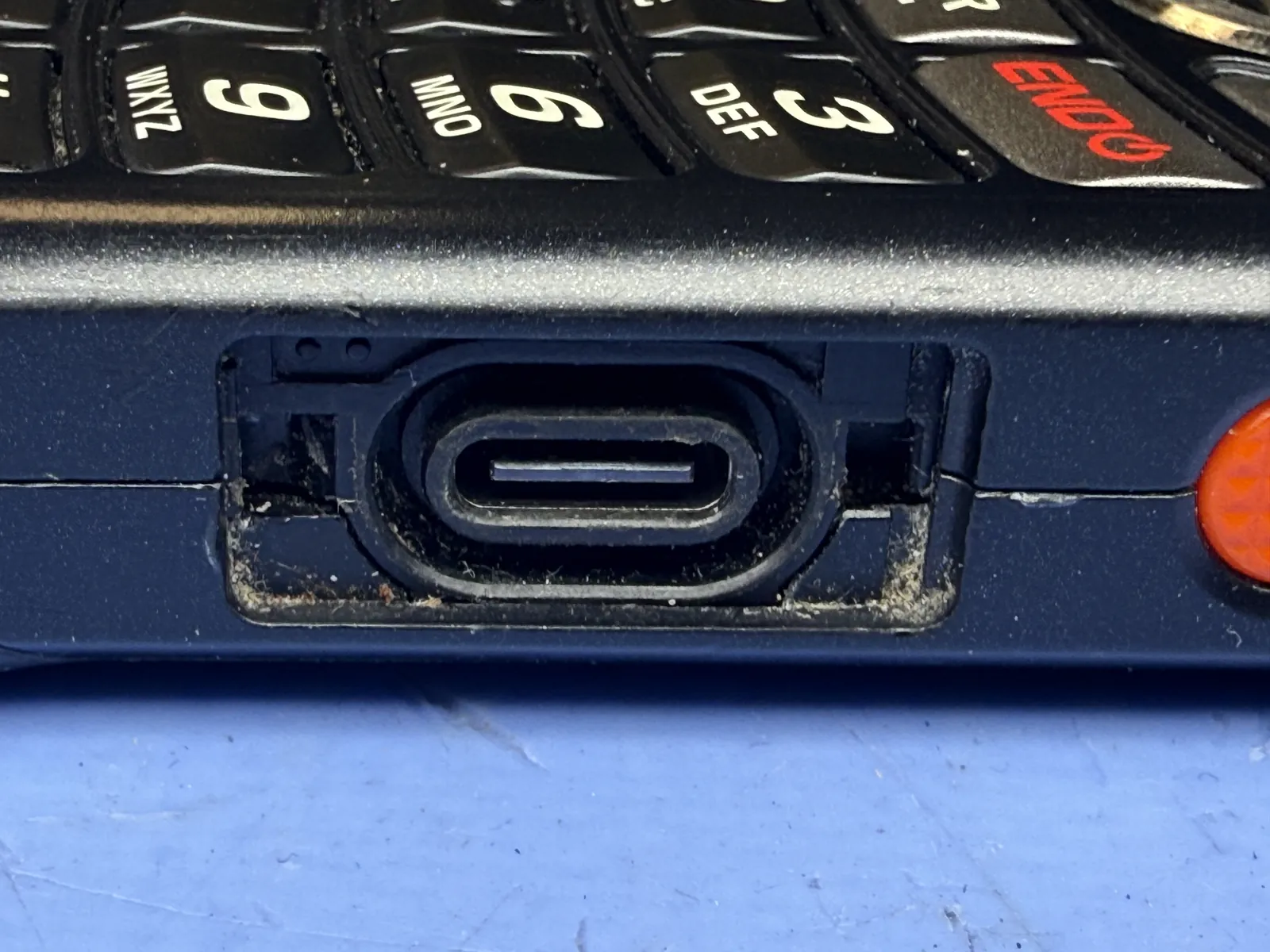 Kyocera DuraXA E4831 charging port after replacement, cable seats correctly