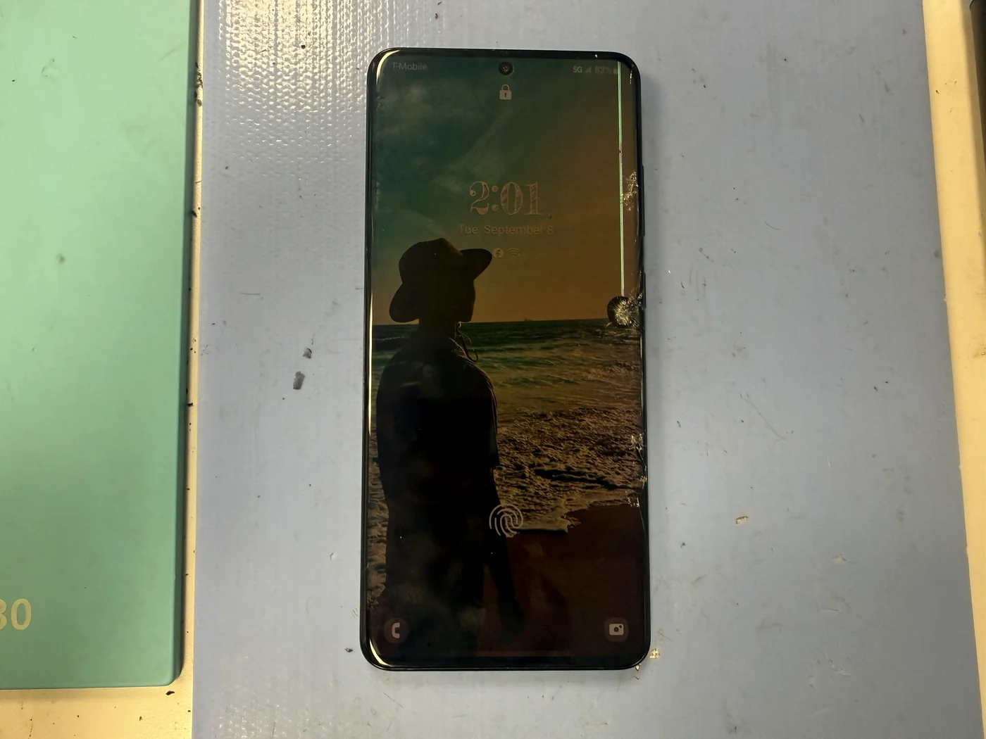 Cracked Galaxy S20 Ultra screen with a green display line, checked in for genuine Samsung screen replacement in Downtown Los Angeles