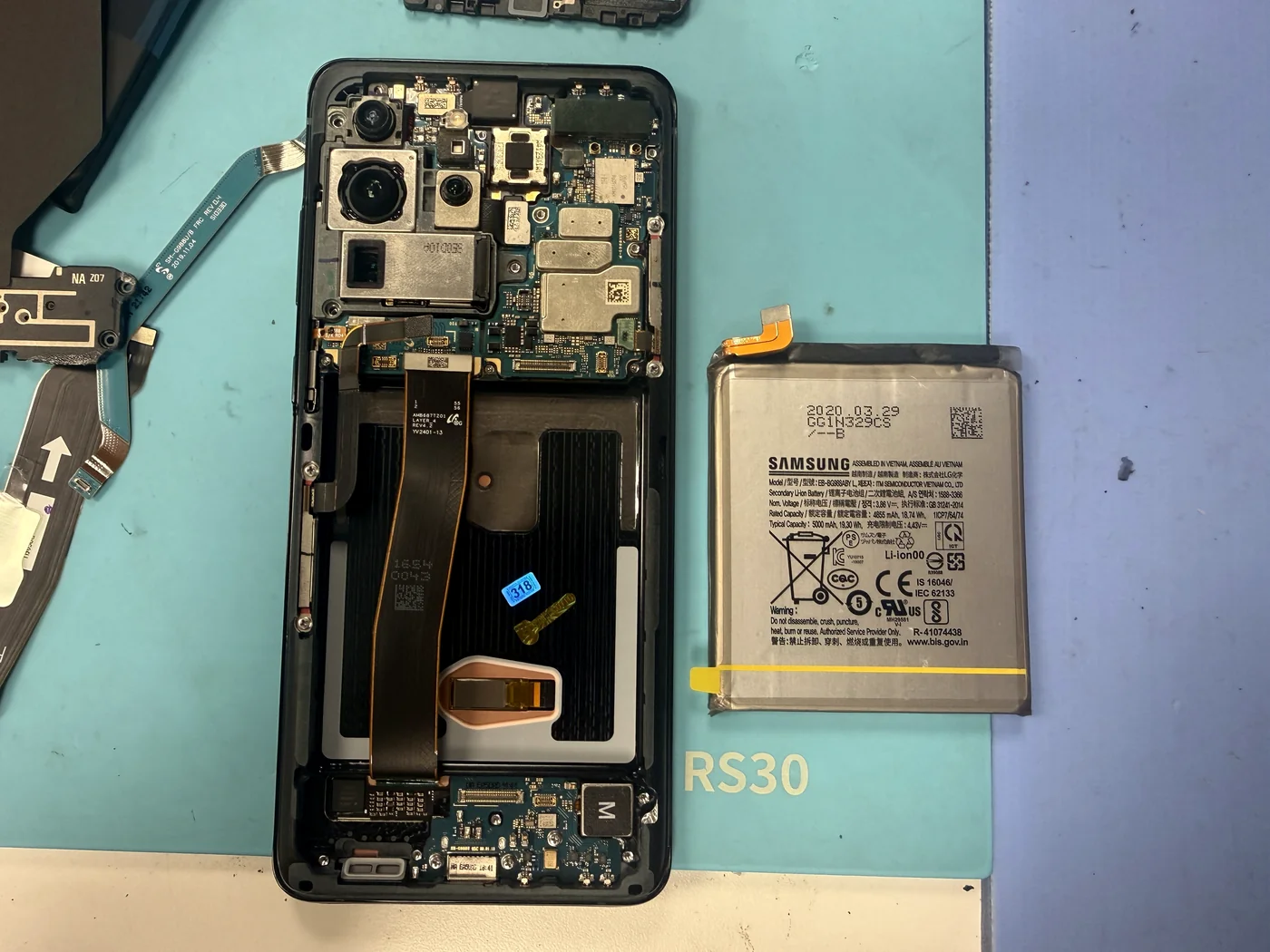 Genuine Samsung Galaxy S20 Ultra battery beside the rebuilt frame during battery replacement in Downtown Los Angeles