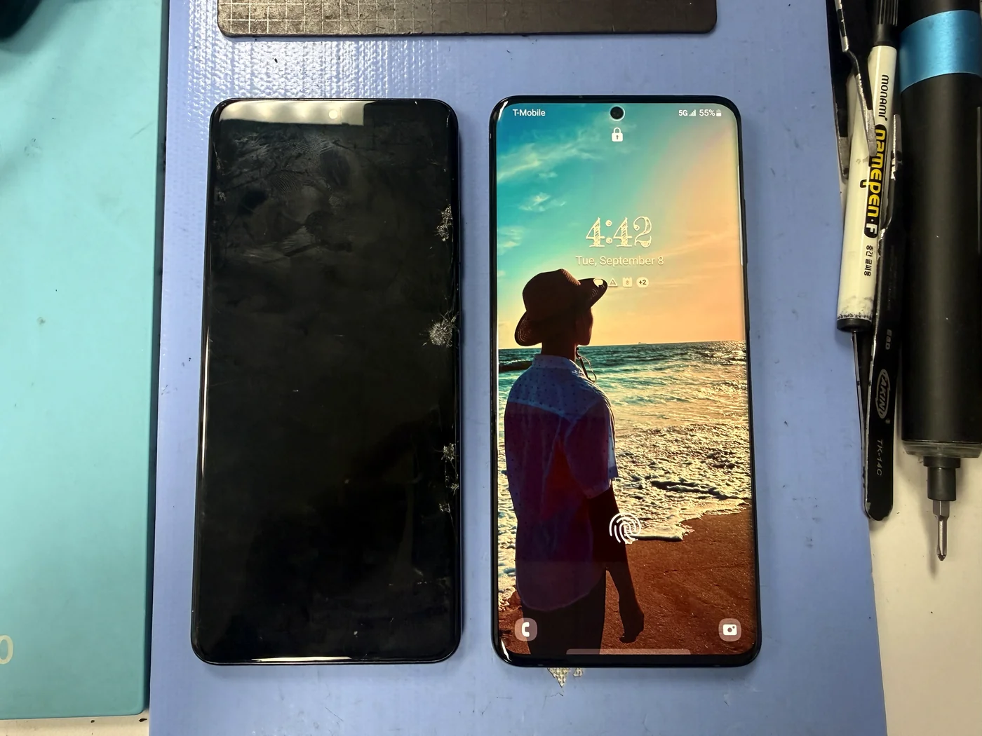 Before and after of a Galaxy S20 Ultra screen replacement, the cracked old panel beside the phone running on its new genuine Samsung display