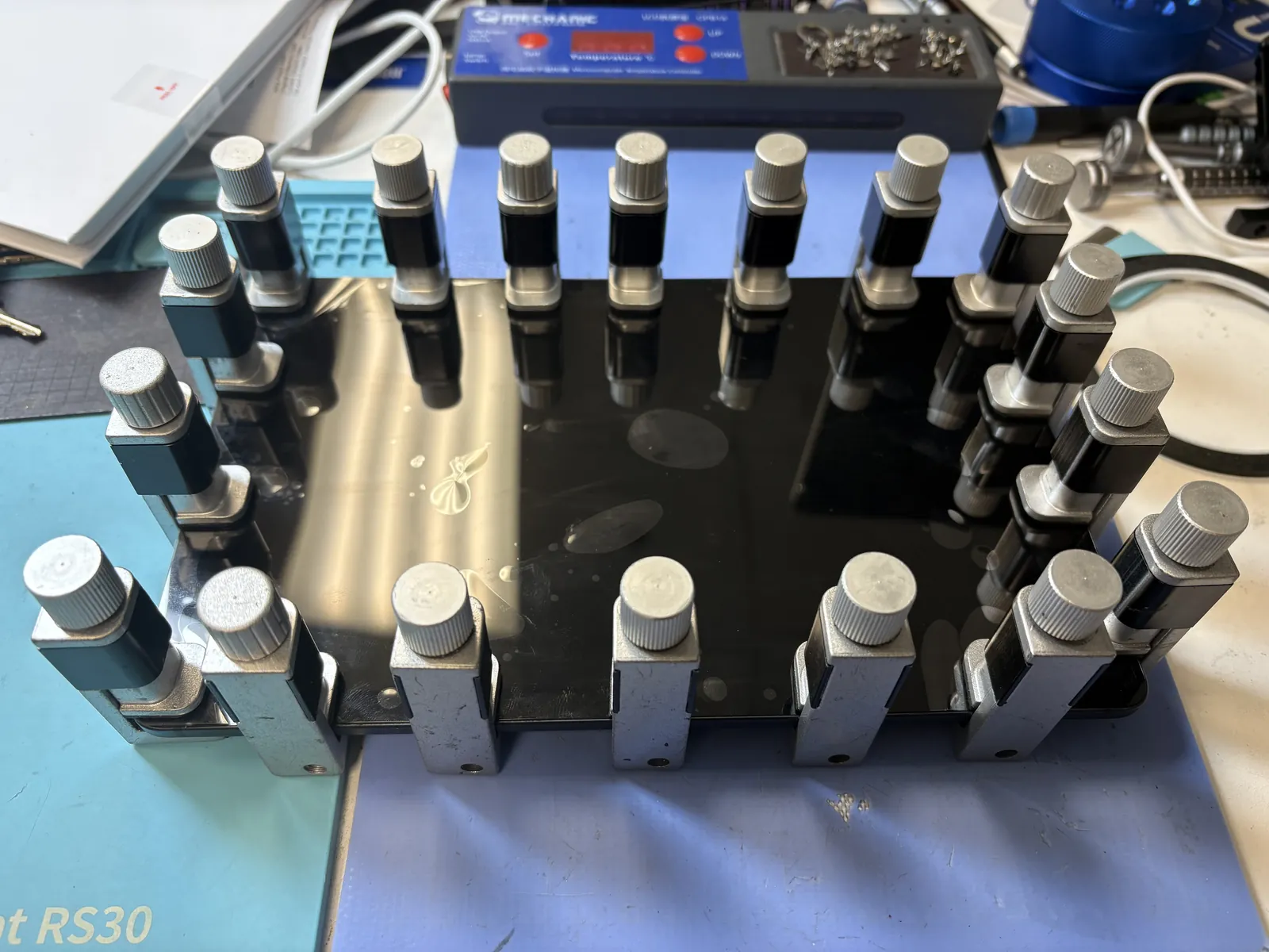 New Galaxy Tab S6 Lite screen assembly clamped down around the perimeter while the adhesive cures on the repair bench