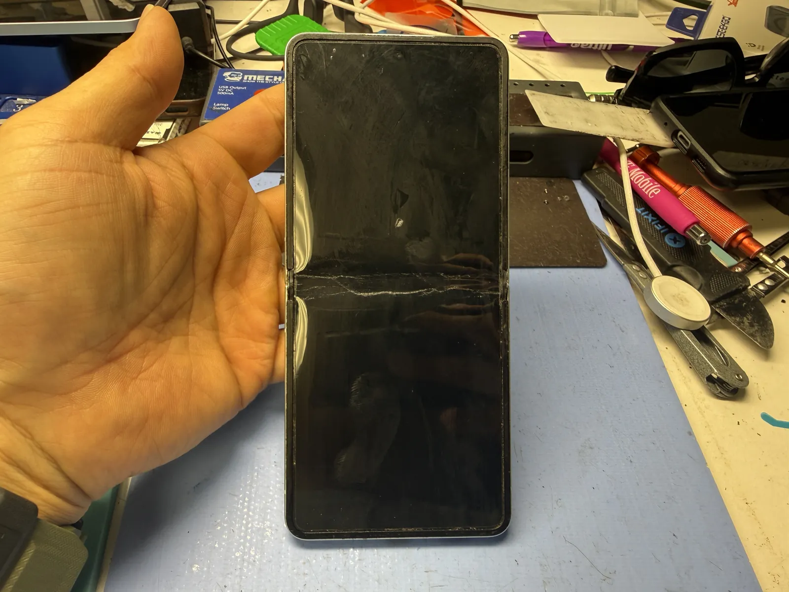Galaxy Z Flip 7 with a dead main screen, showing nothing but black, as it came in