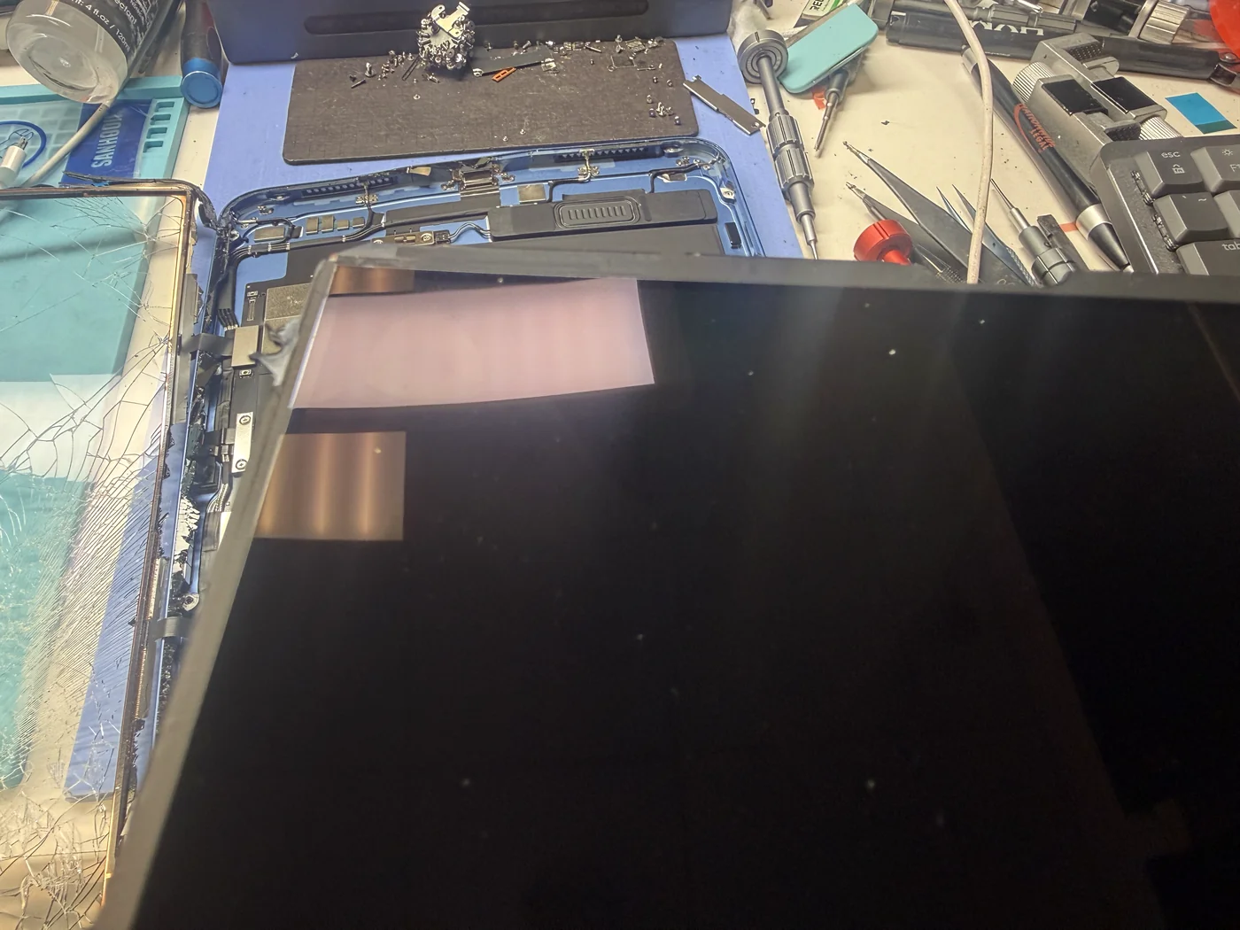 Genuine test LCD connected to the iPad 11-inch (2025) logic board on the bench