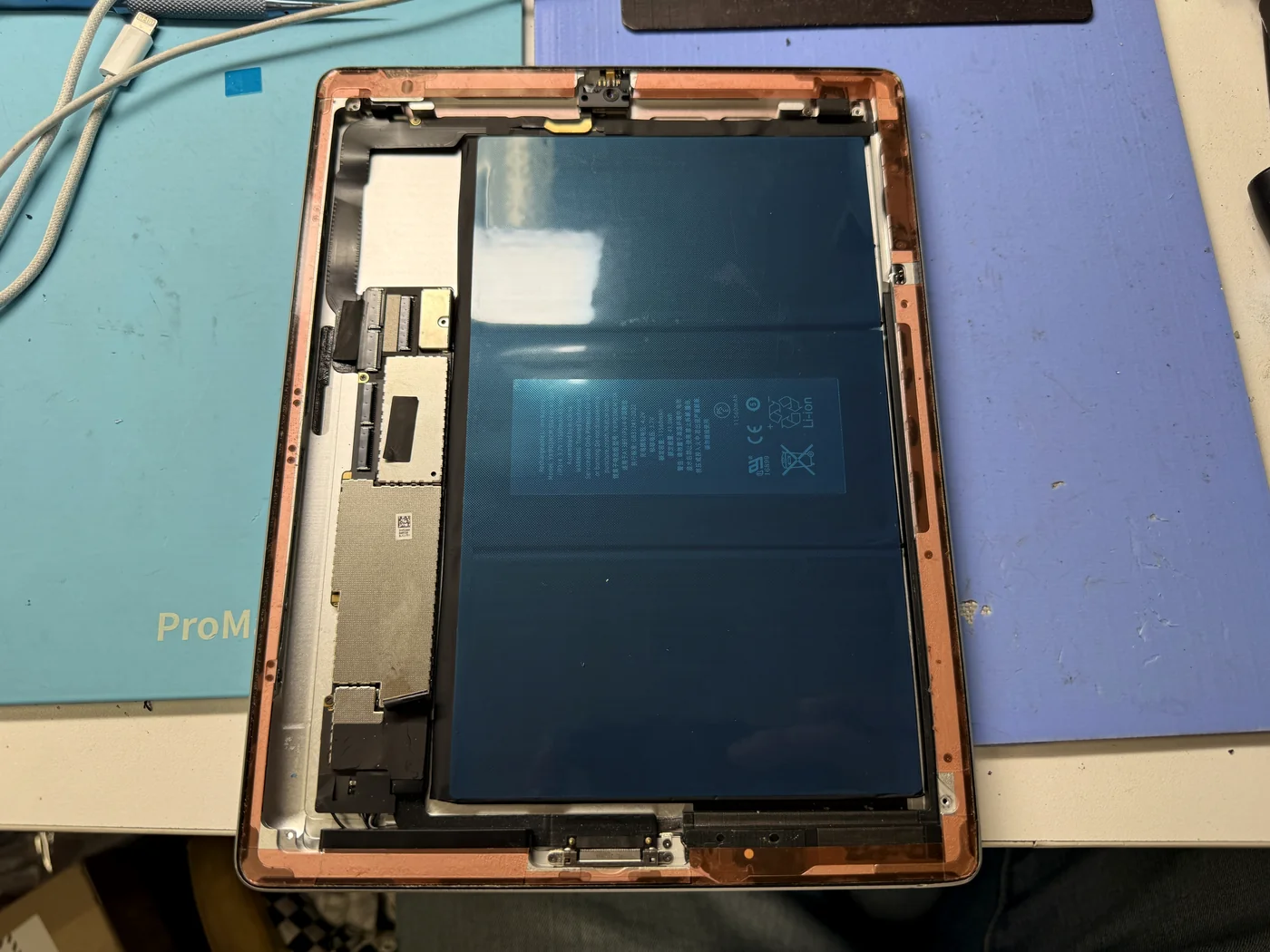 Fresh double-sided adhesive tape applied around the iPad 3 bezel before refitting the digitizer