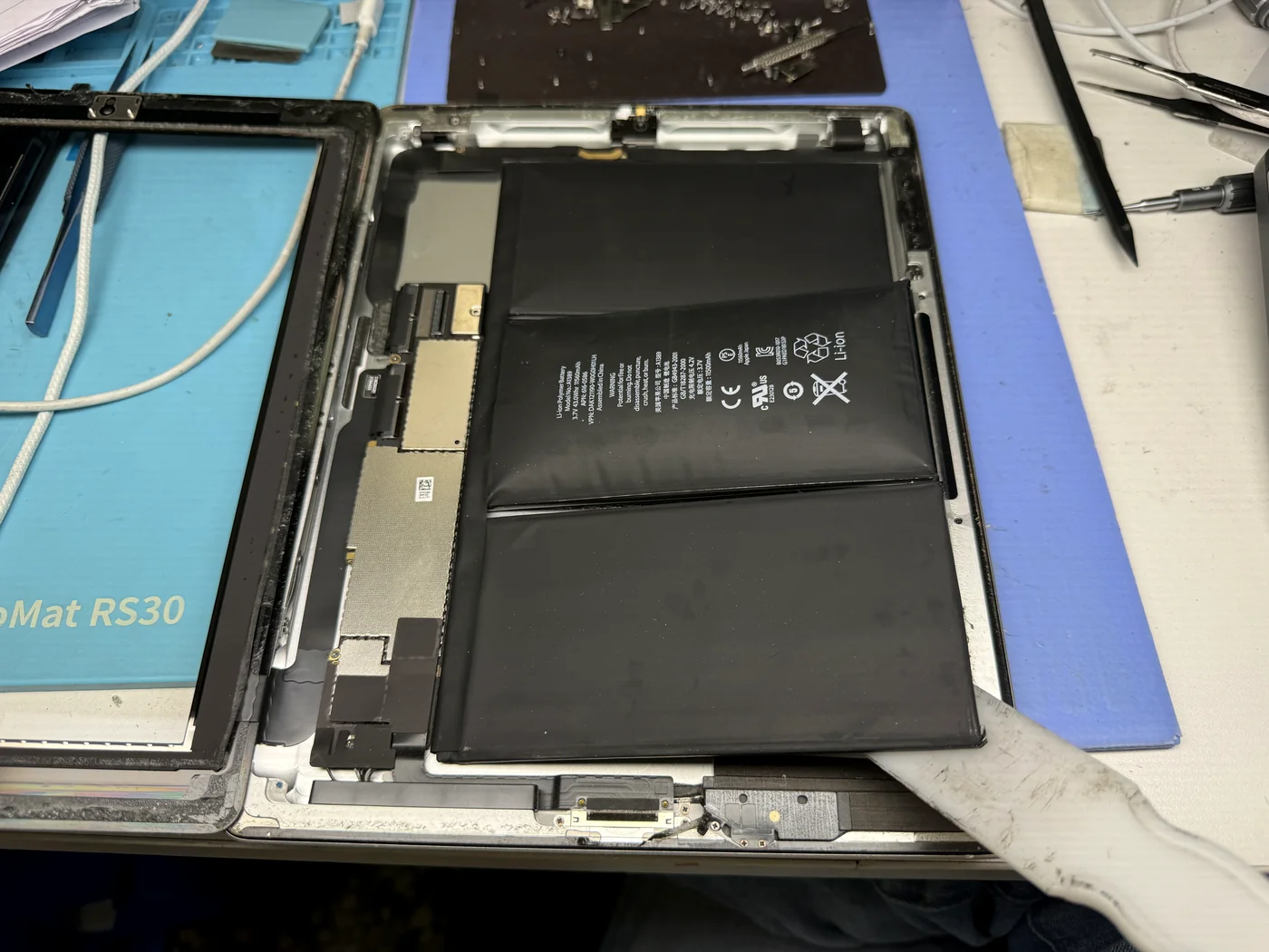 Swollen iPad 3 battery being separated from the rear housing during battery replacement
