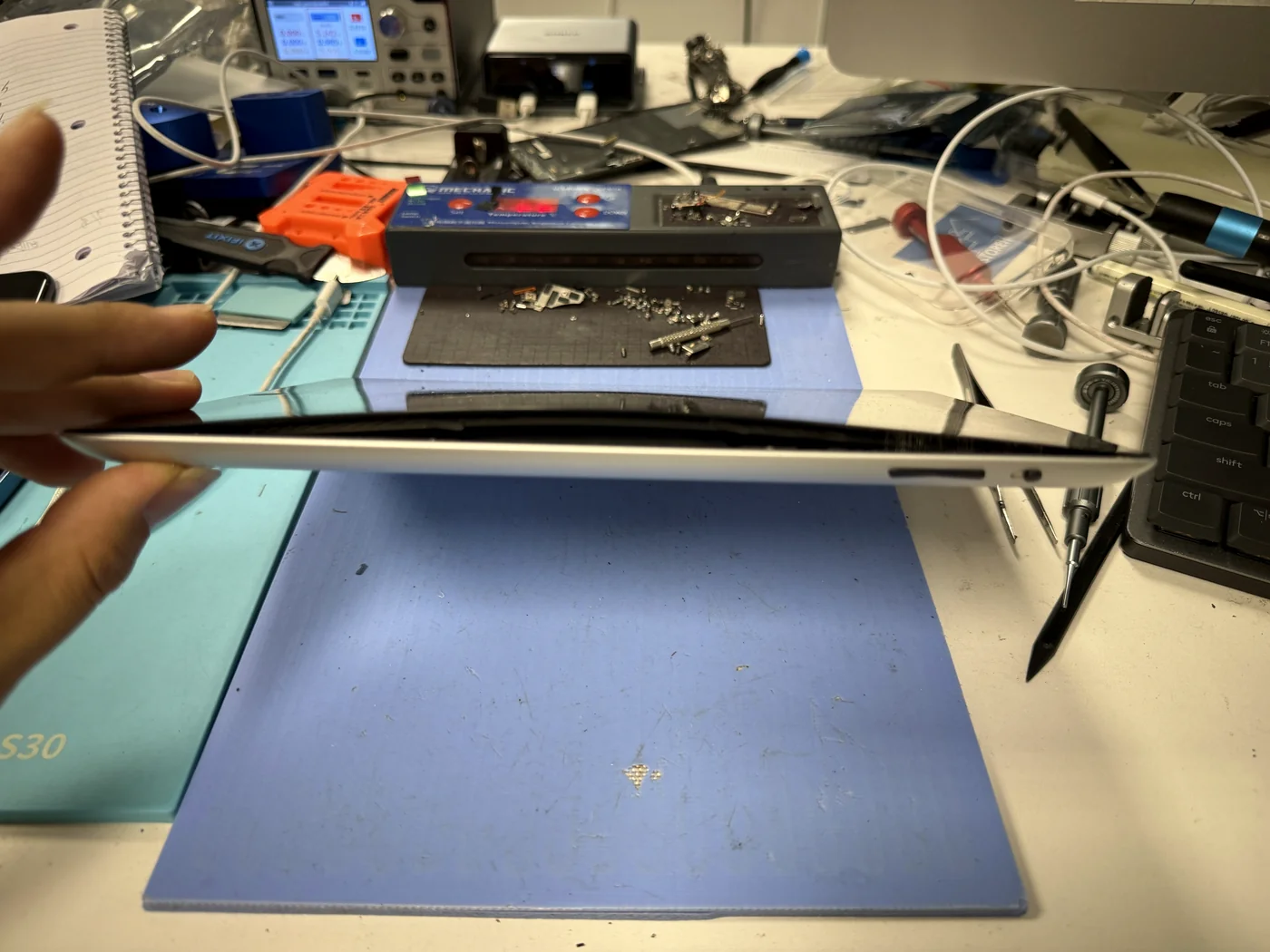 iPad 3 seen edge-on with the side seam pushed open by a swollen battery, checked in at FIXSTORY DTLA in Downtown Los Angeles
