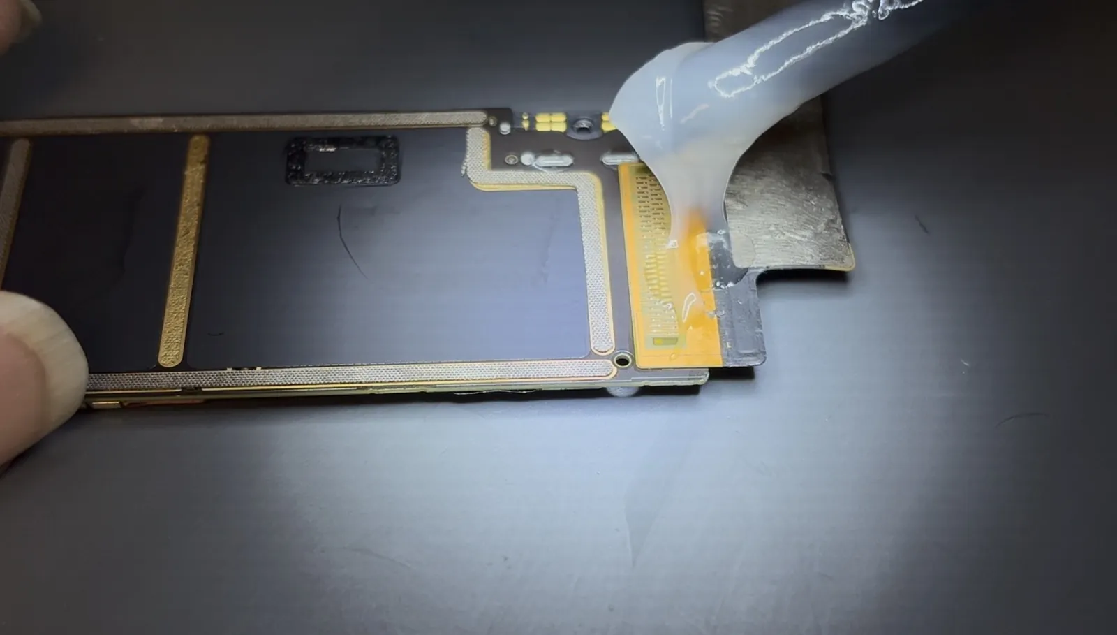 Flux applied to the old iPad Air 4 charging port joints before desoldering