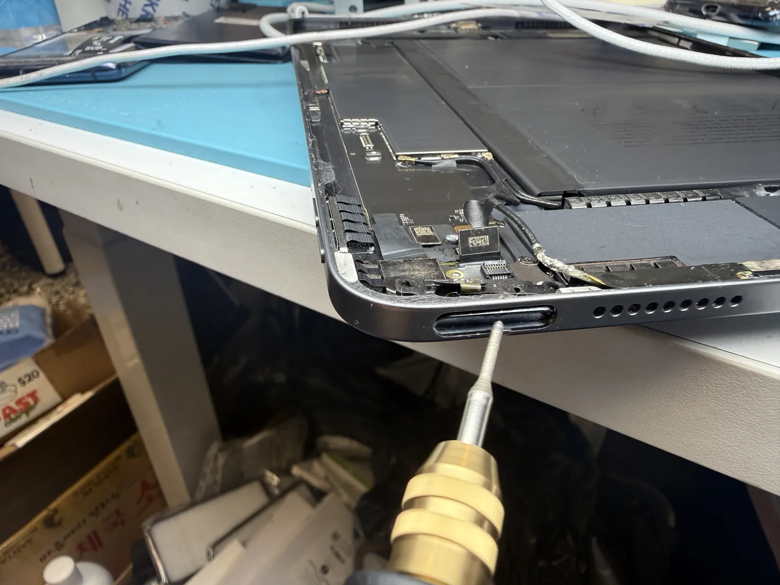 Reshaping the bent iPad Air 4 frame from the inside so the power button can move freely
