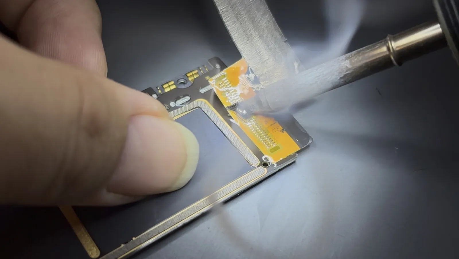 Desoldering the failed charging port from the iPad Air 4 with a soldering iron