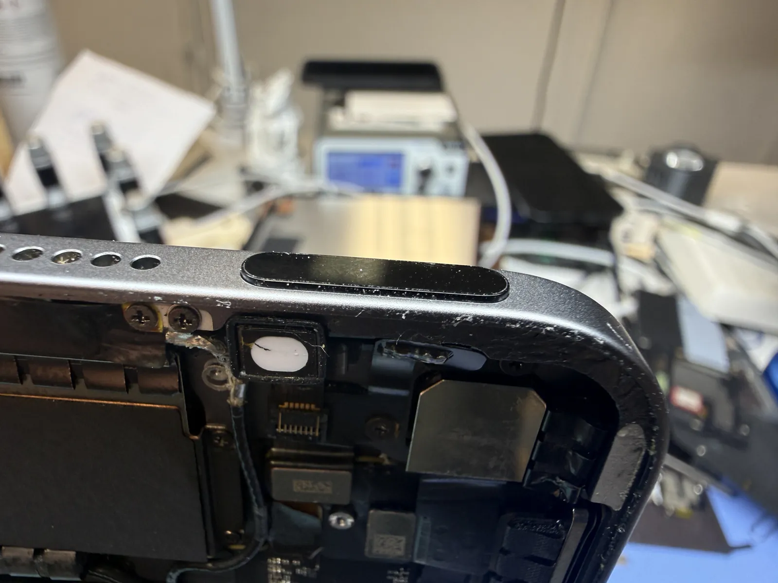 The repaired iPad Air 4 power button sitting proud of the frame and moving freely again