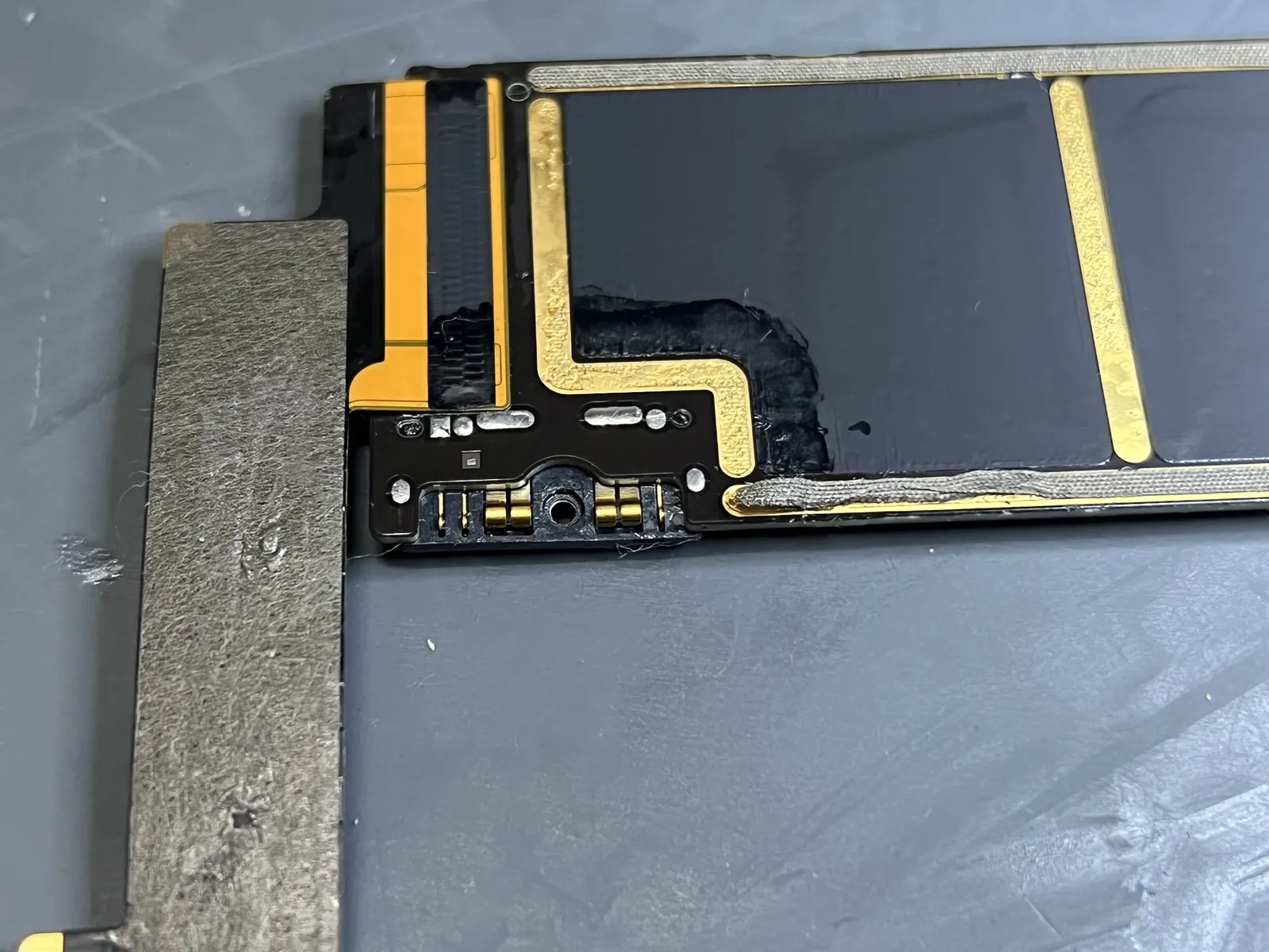 Soldering the new battery connector onto the iPad Air 4 board