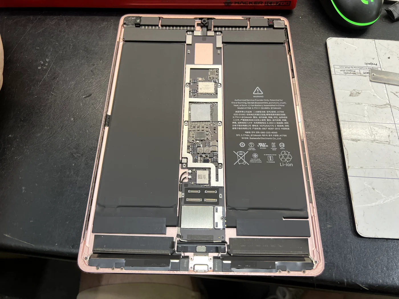 iPad Pro 10.5 opened with the screen separated and the logic board and battery exposed