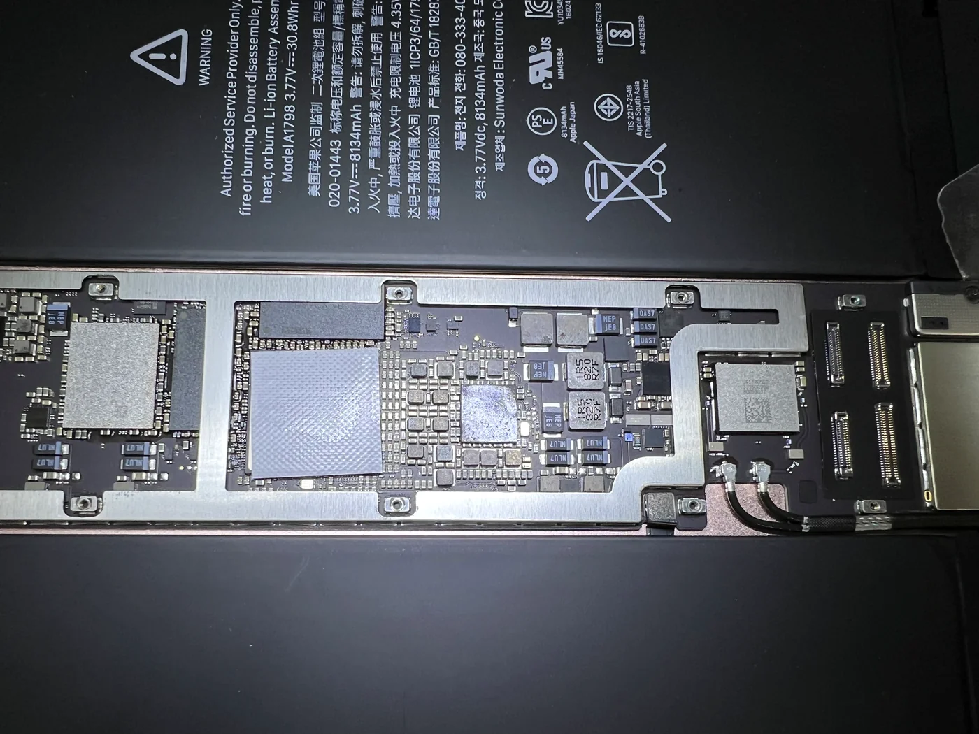 Close-up of the iPad Pro 10.5 logic board around the power management chip where the coils come loose