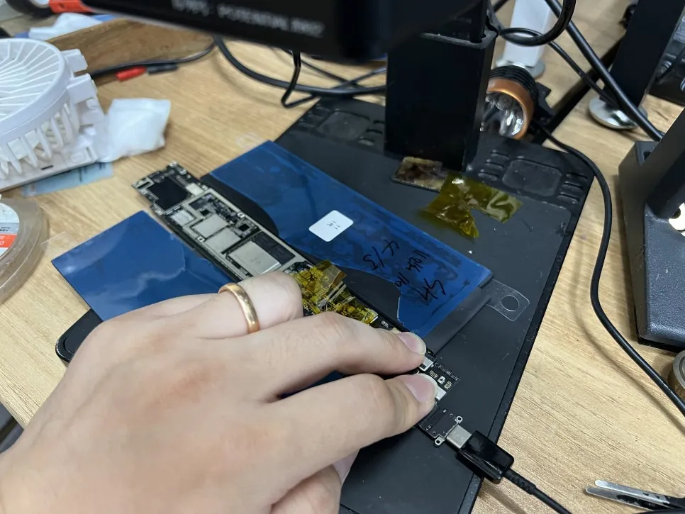 The iPad Pro 11 logic board out of the housing and under the microscope for inspection
