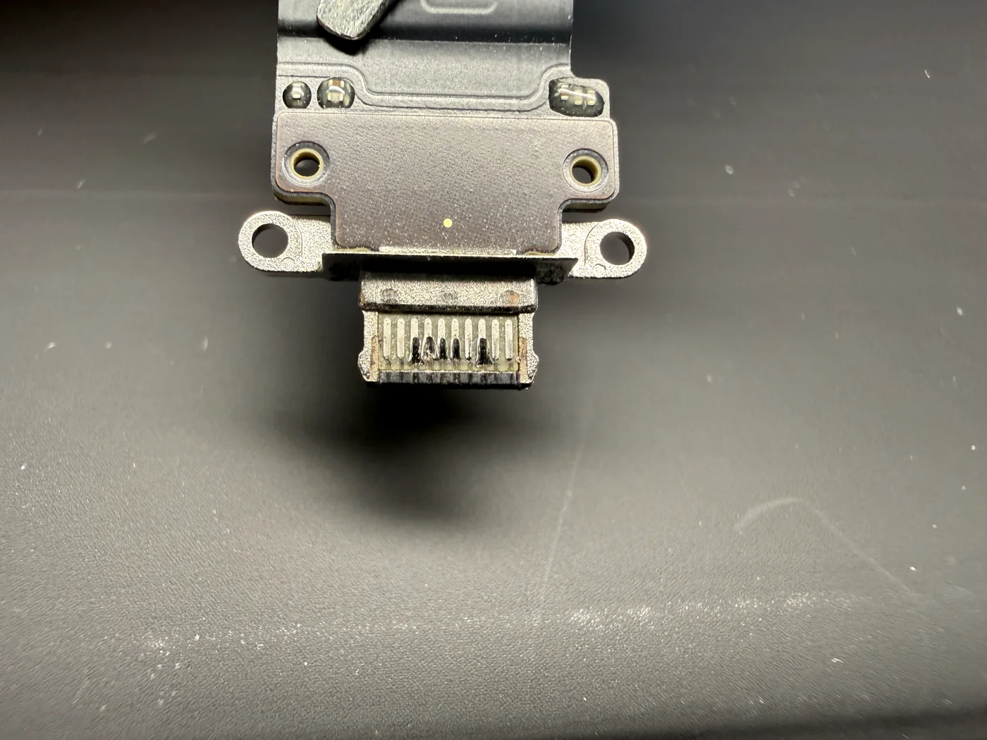Close-up of a faulty iPad Pro 12.9 3rd gen charging port with bent and discolored pins
