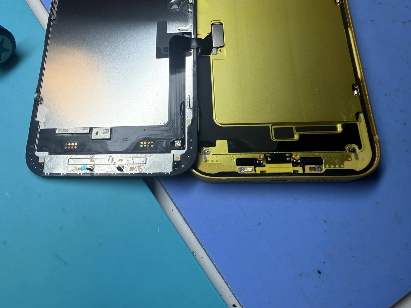 Water marks on the lower edge of an iPhone 14 Plus screen and inside the frame