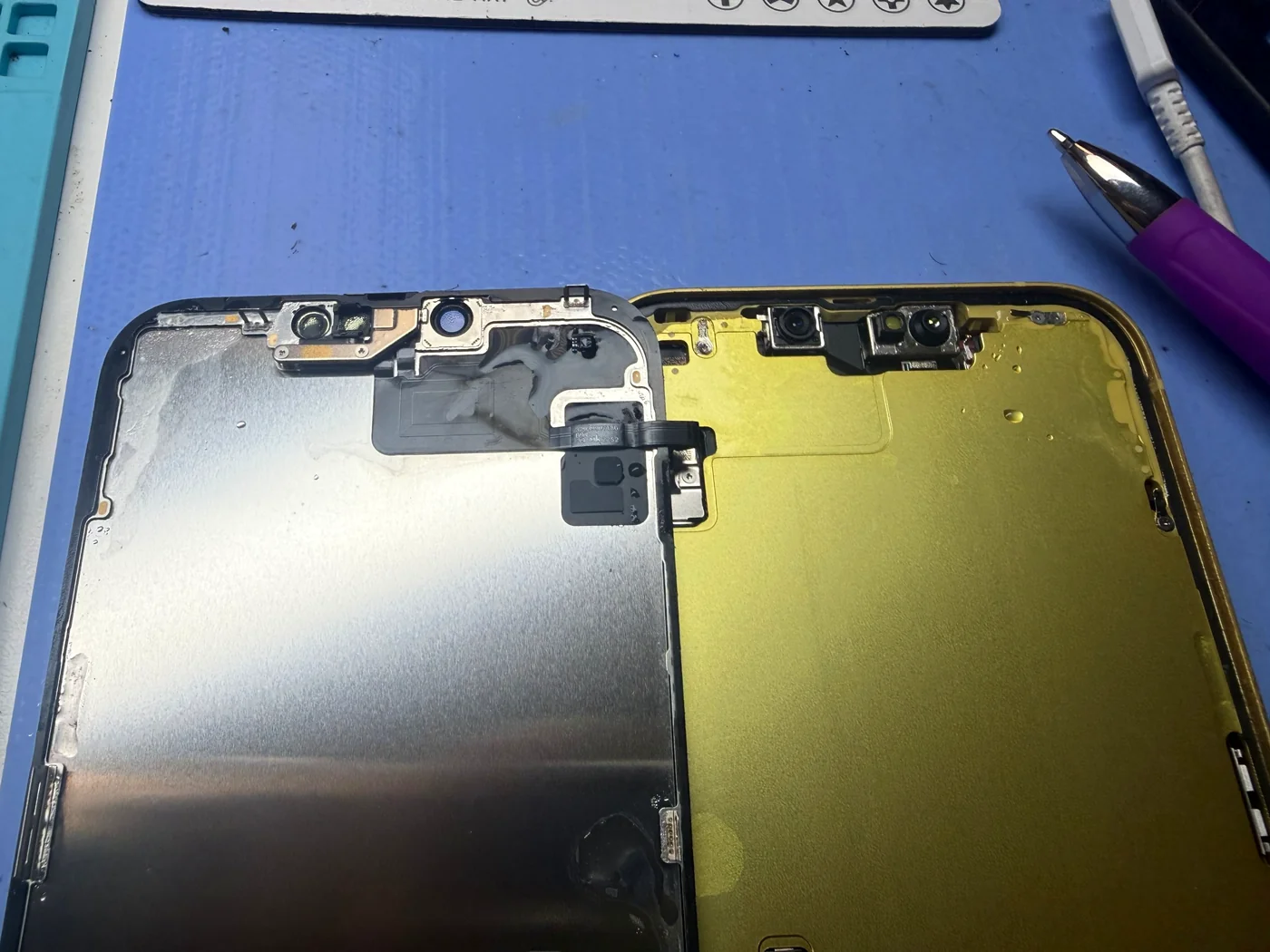 Water residue on the back of an iPhone 14 Plus screen around the front camera and sensor bracket