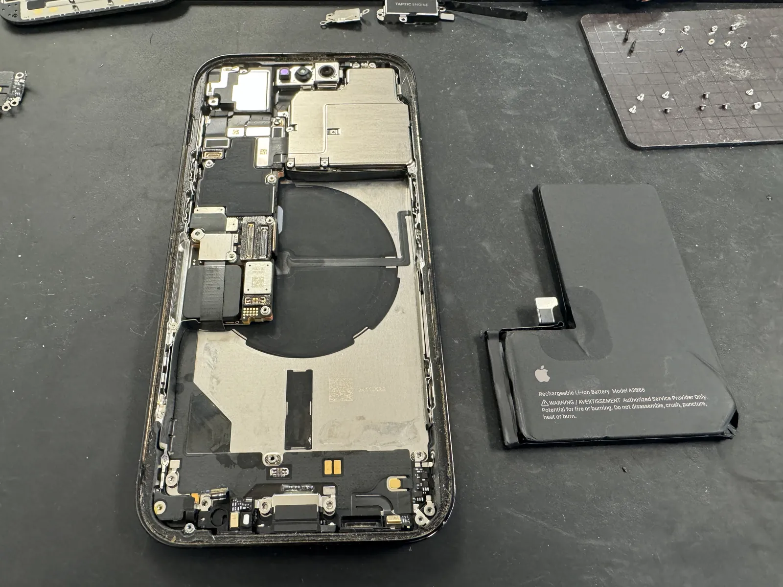 iPhone 14 Pro battery removed to reach the charging port flex underneath