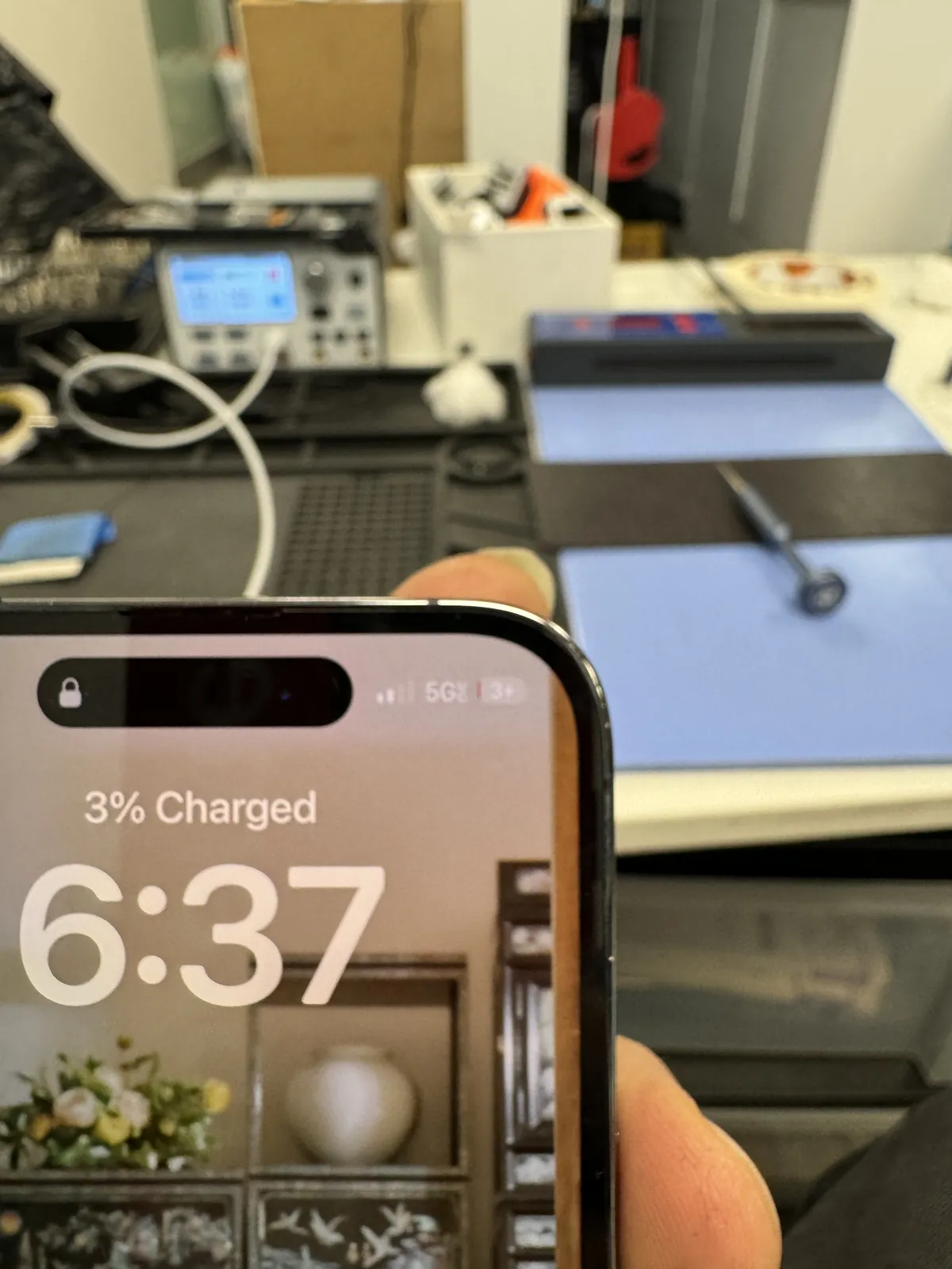 iPhone 14 Pro lock screen showing 3 percent charged — the first successful charge after the charging IC replacement
