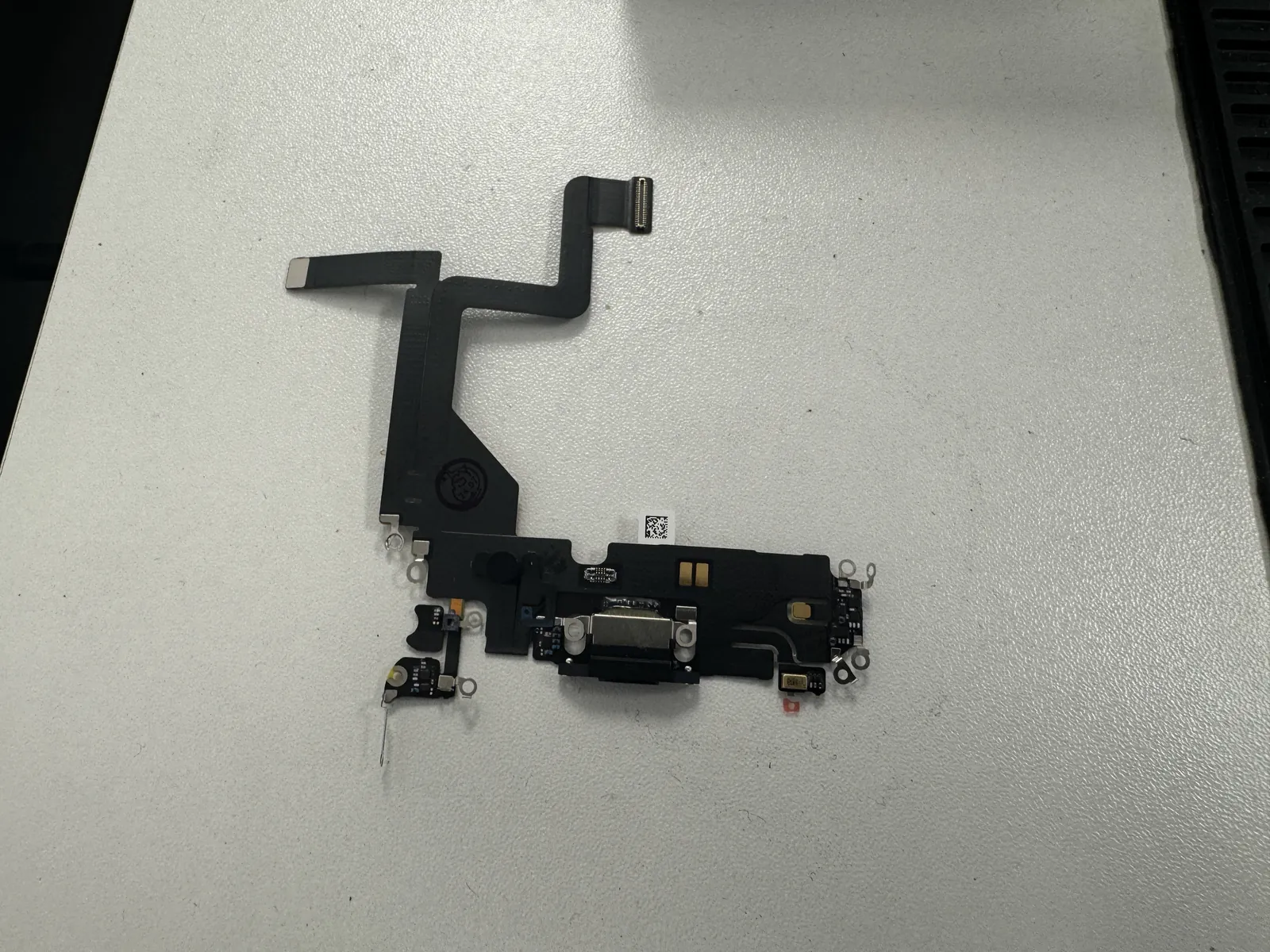 Genuine Apple charging port flex assembly ready to go into the iPhone 14 Pro