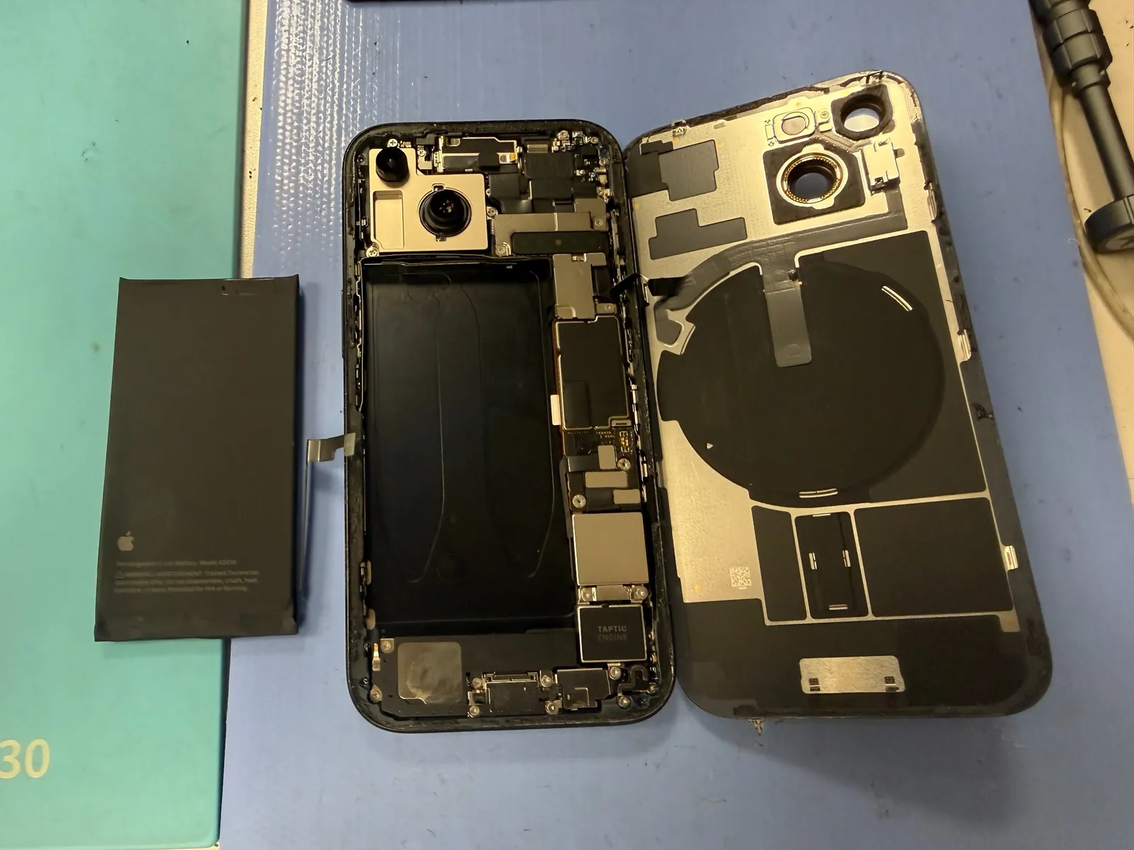 Inside an iPhone 15 after the original battery has been removed