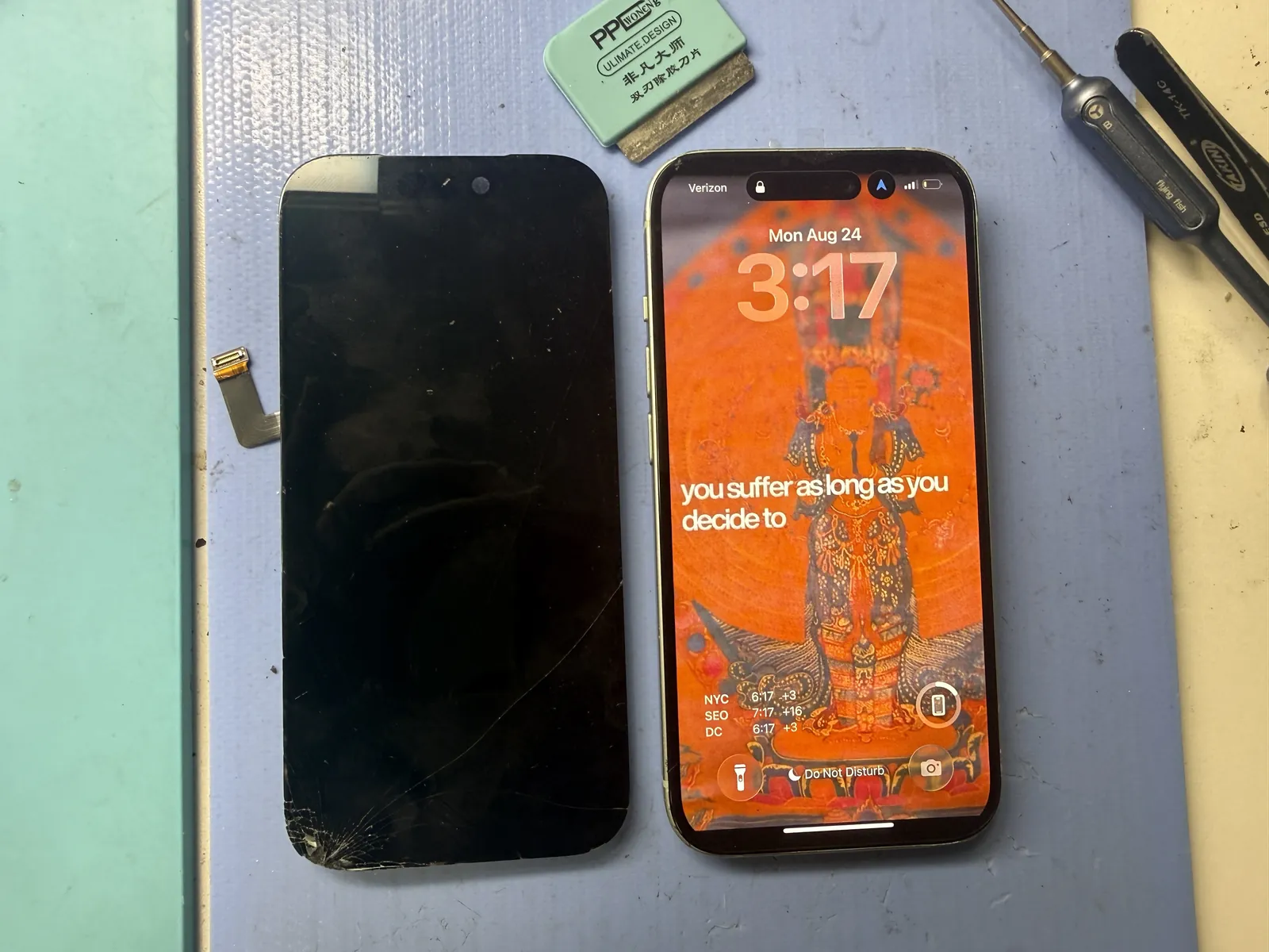 iPhone 15 screen replacement in Downtown Los Angeles — cracked original panel next to the phone running its new aftermarket OLED screen