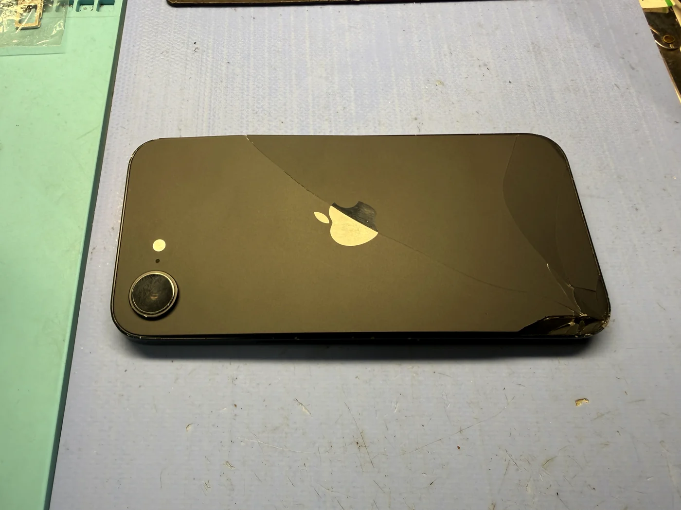 iPhone 16e back glass cracked by pressure from a swollen battery