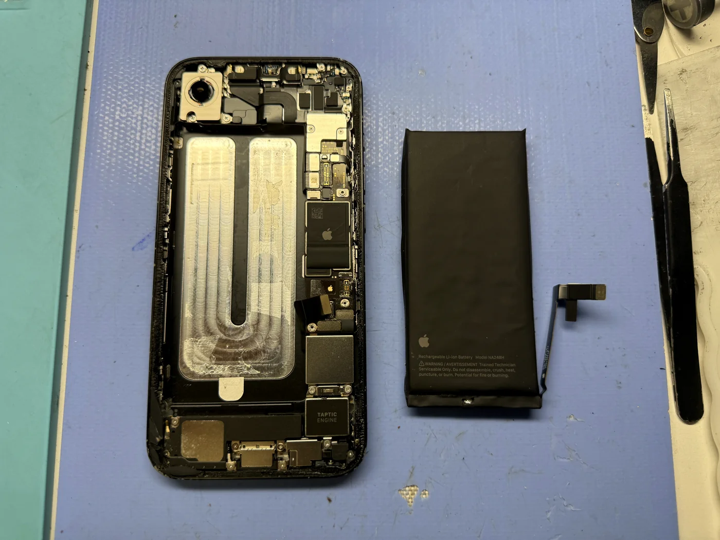 Swollen iPhone 16e battery removed from the body