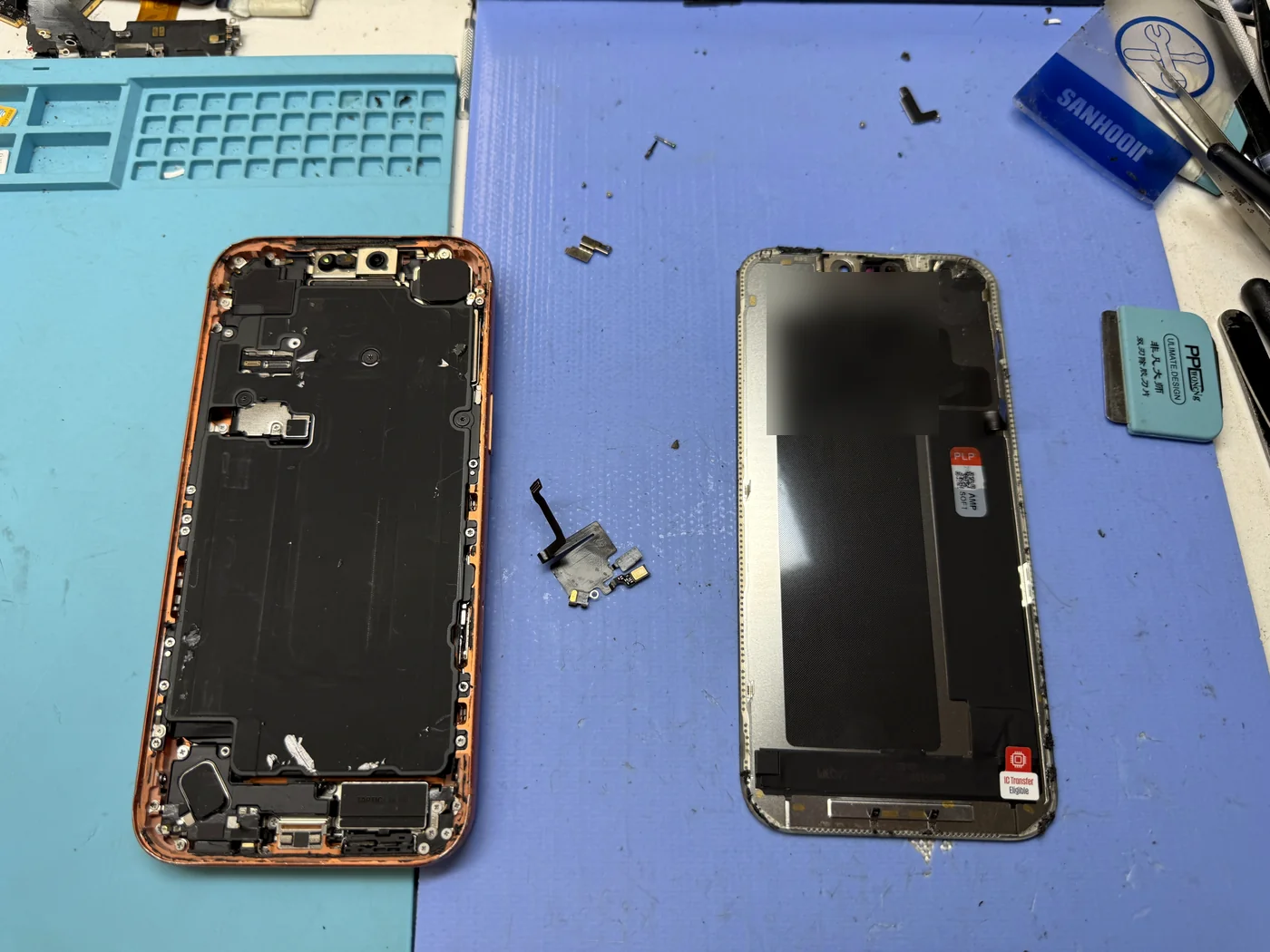 iPhone 17 Pro frame with the display removed beside the old screen