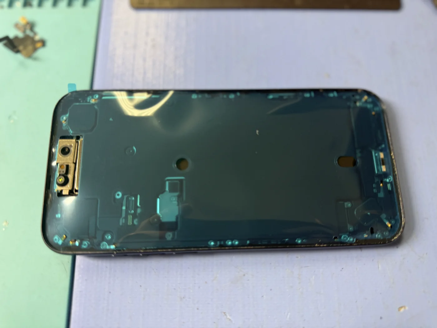 iPhone 17 Pro Max frame with the old waterproof seal removed and a fresh seal applied before fitting the new screen