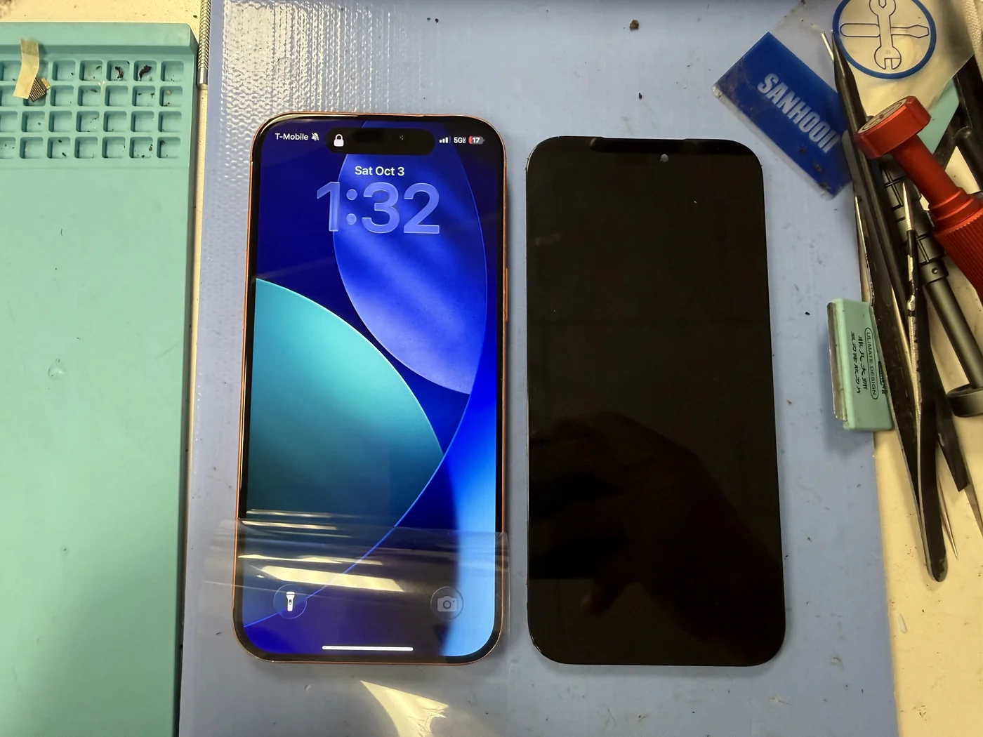 iPhone 17 Pro with a new screen working on the lock screen beside the old display