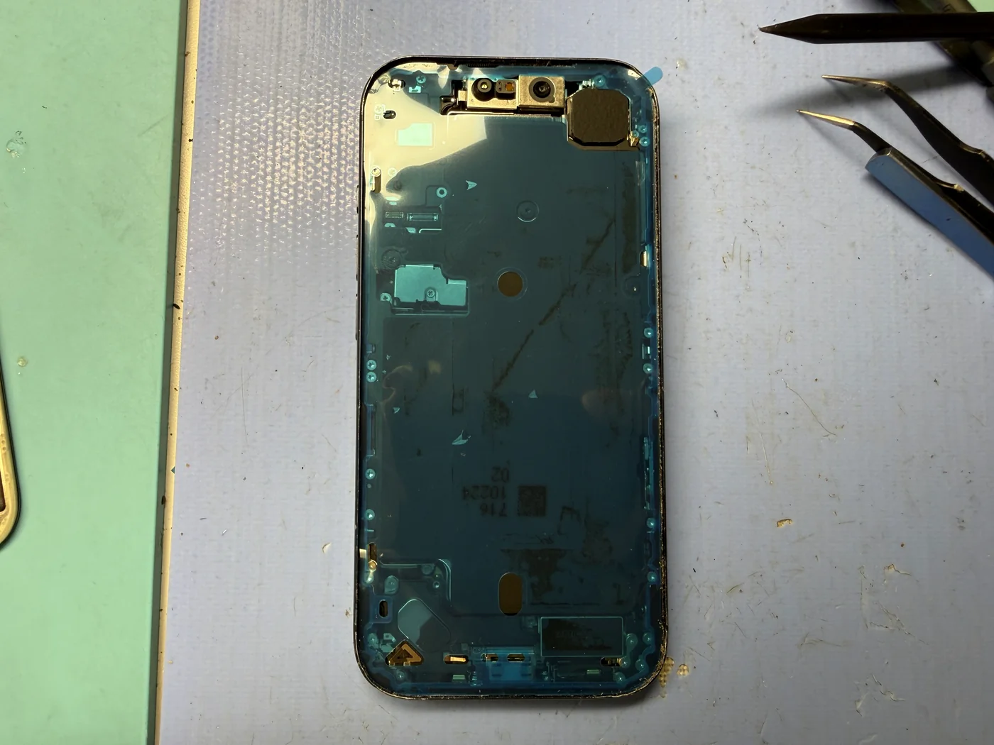 Fresh water-resistant adhesive seal applied around the iPhone 17 Pro chassis
