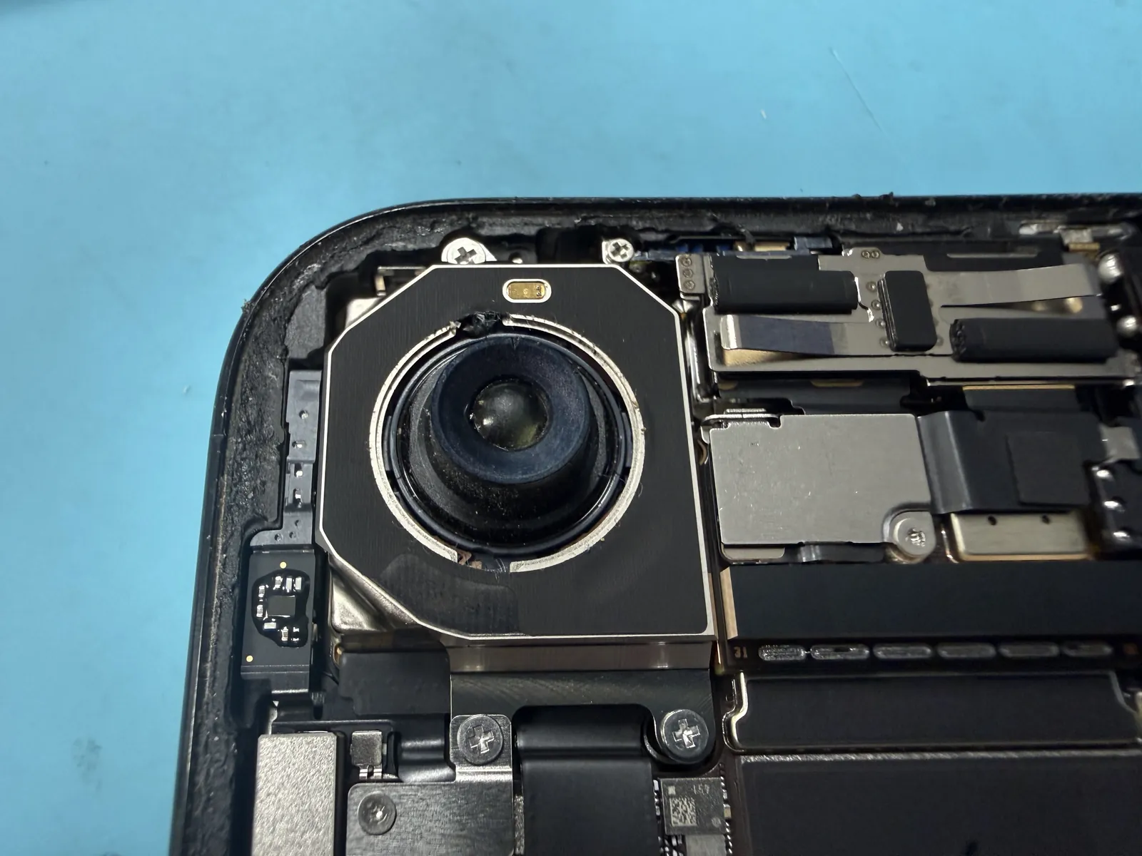 Close-up of the old iPhone Air camera — genuine, but dirty and showing housing damage