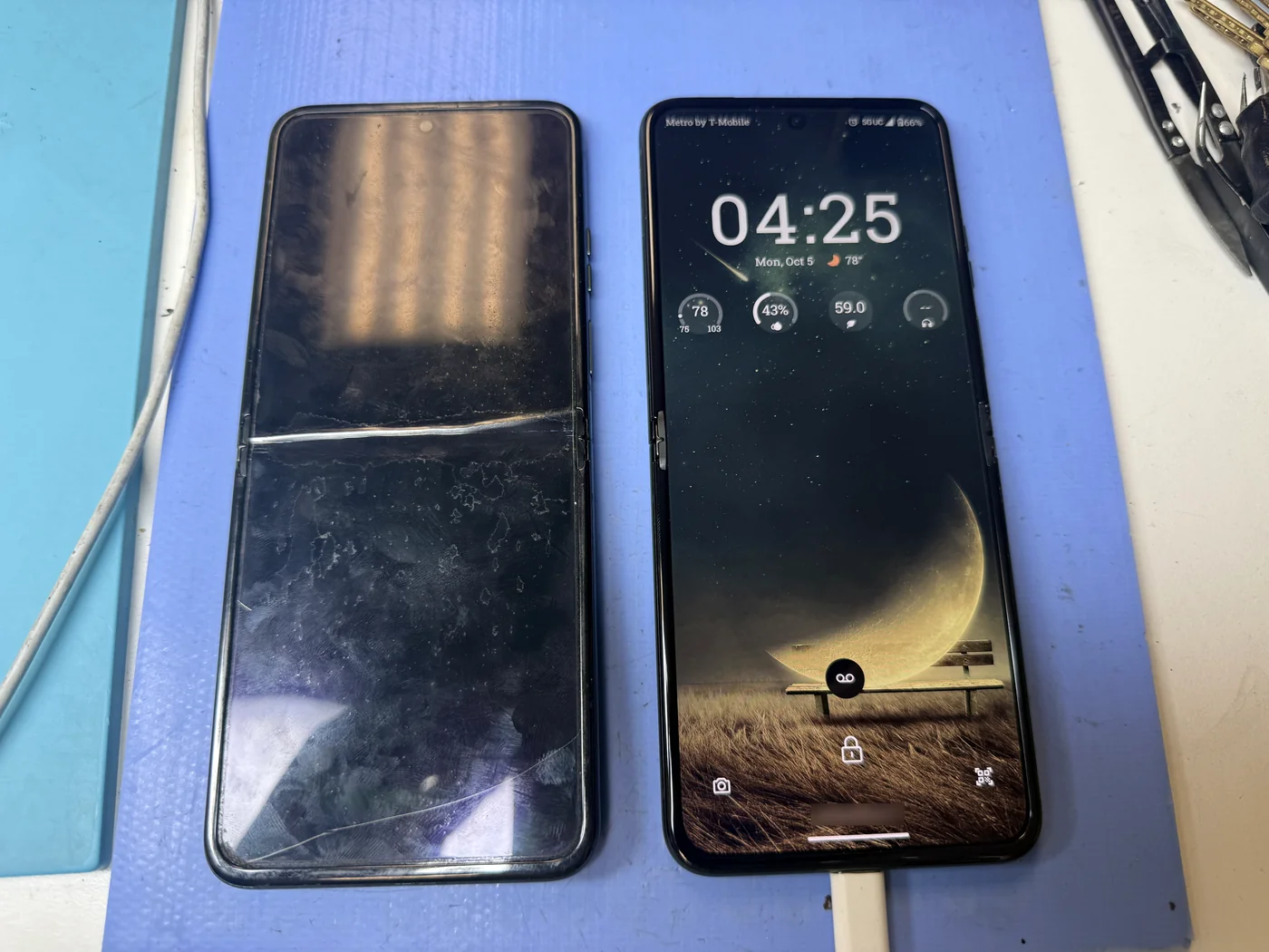 Repaired Motorola Razr 40 booted to the lock screen on its new inner folding display next to the old cracked screen at FIXSTORY in Downtown Los Angeles