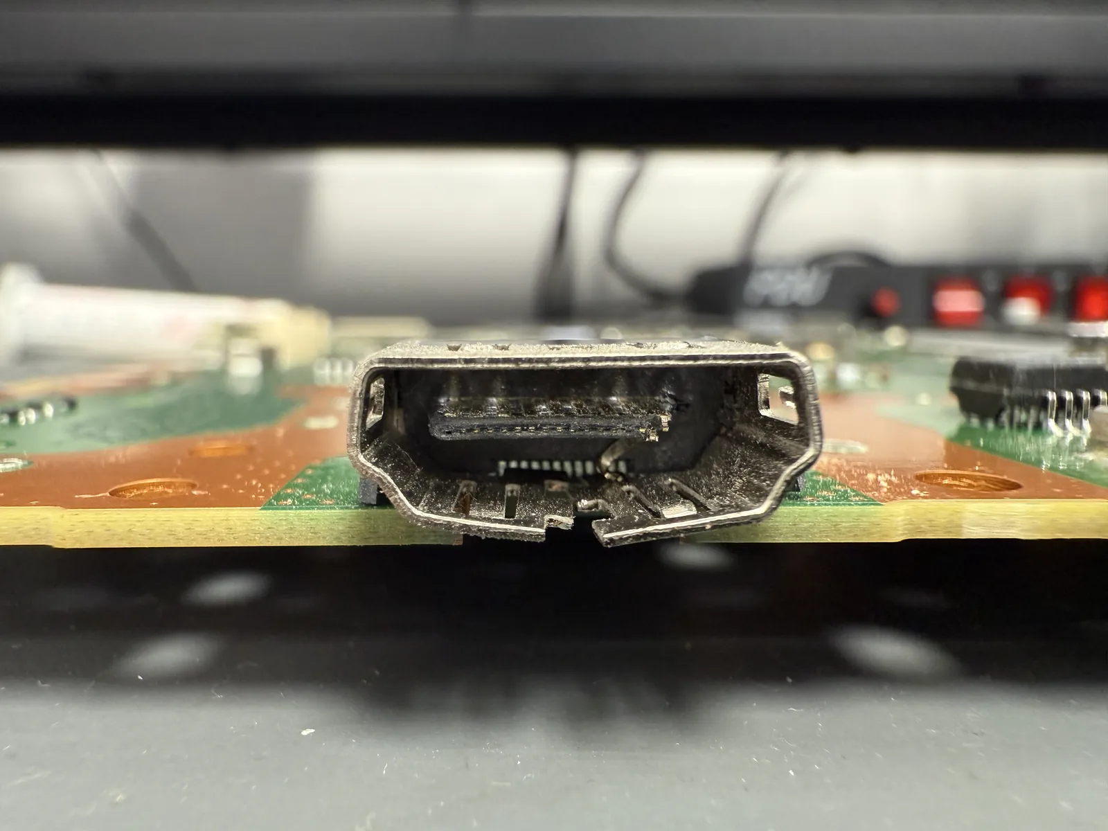 Close-up of the broken PS5 HDMI port with bent, pushed-in pins