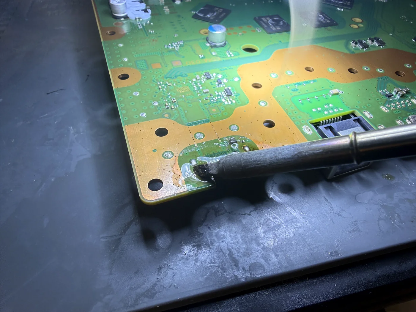 Soldering the replacement capacitor and preparing the PS5 HDMI port pads