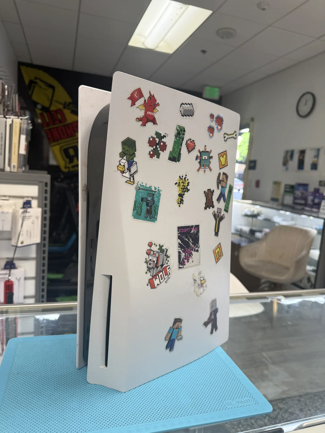 PS5 disc edition covered in Minecraft stickers, checked in for HDMI port repair at FIXSTORY DTLA, Downtown Los Angeles