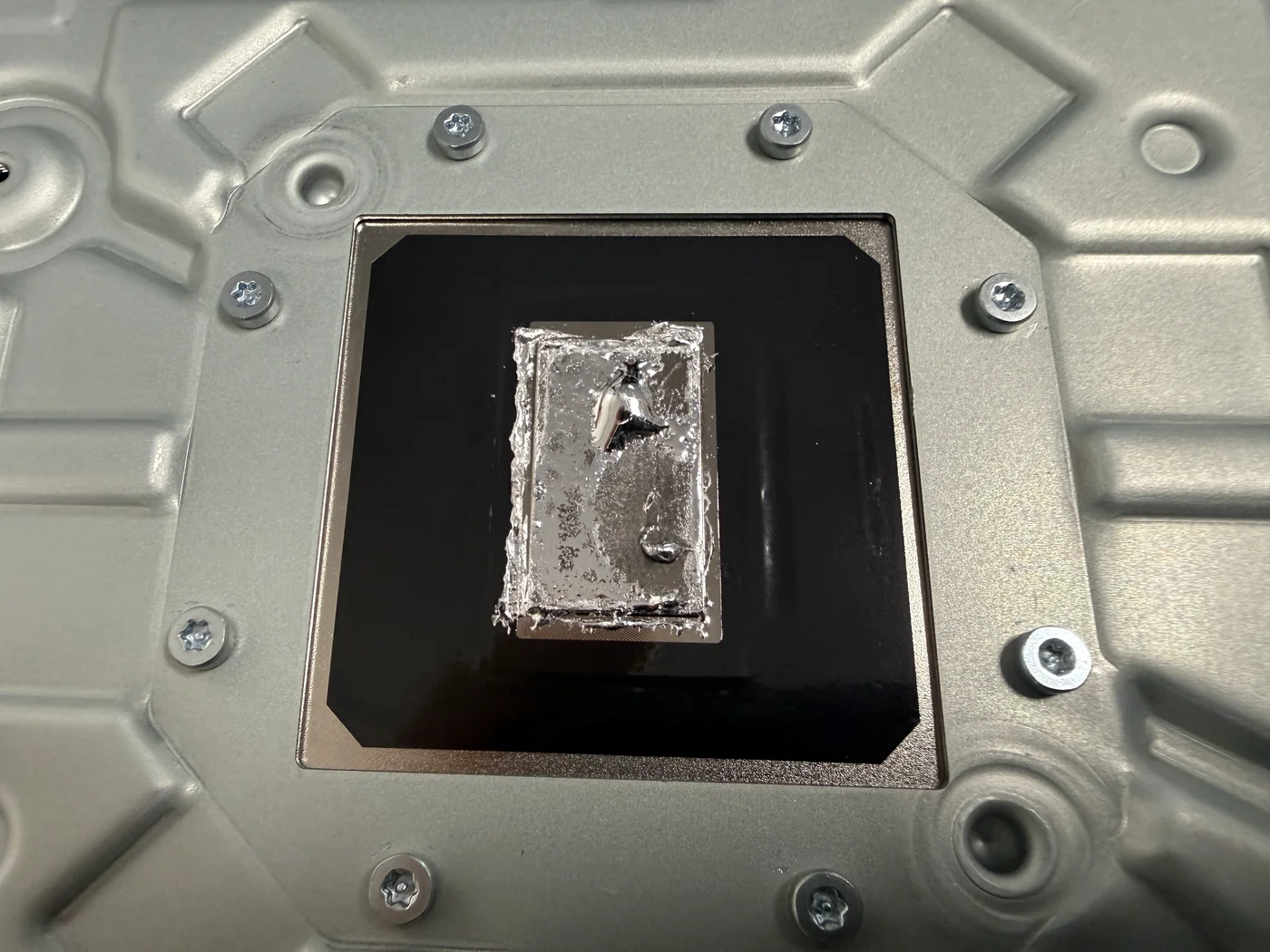 Old, dried and clumped liquid metal on the PS5 heatsink contact plate