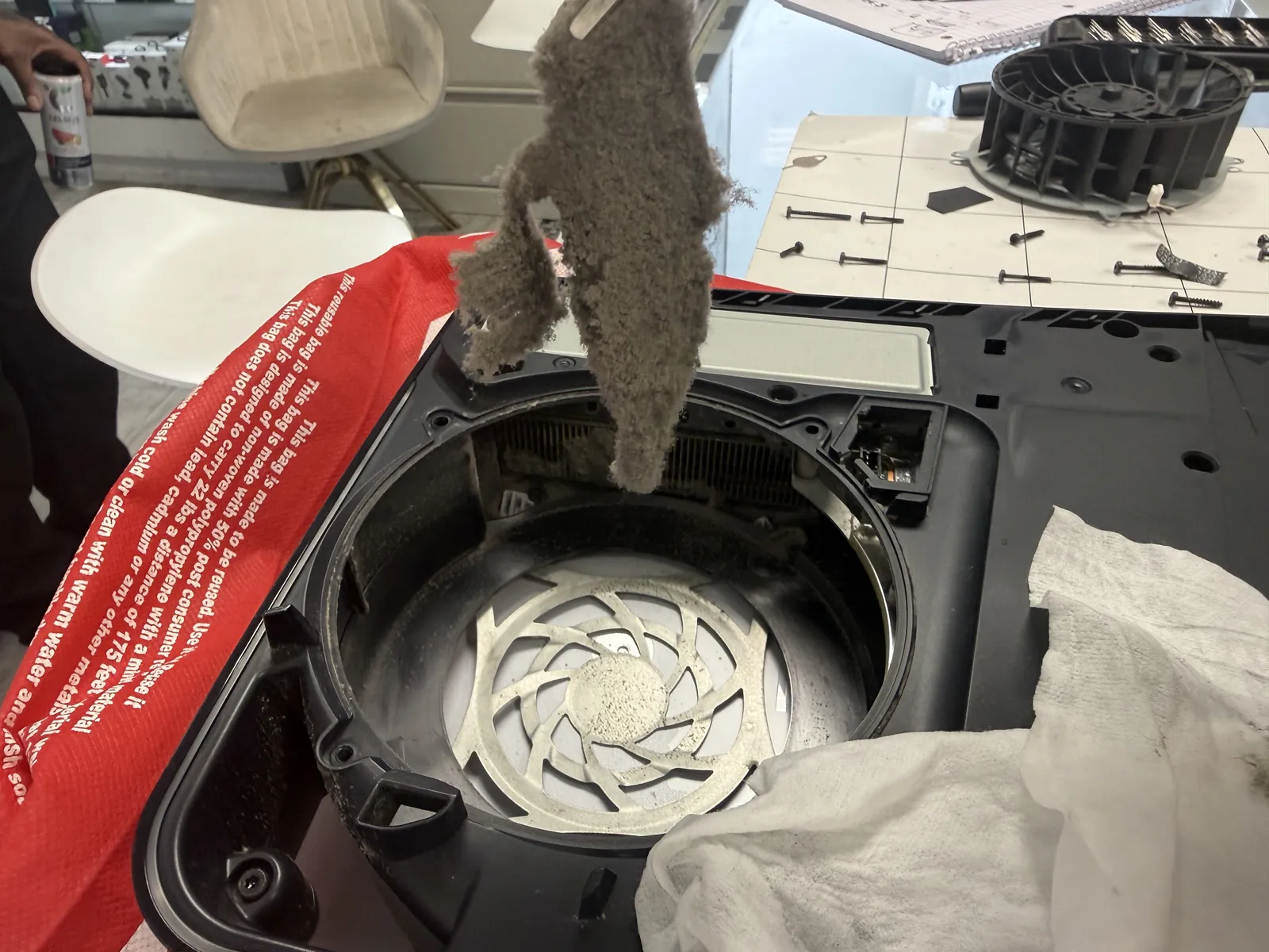 A whole sheet of packed dust being lifted out of the PS5 during cleaning