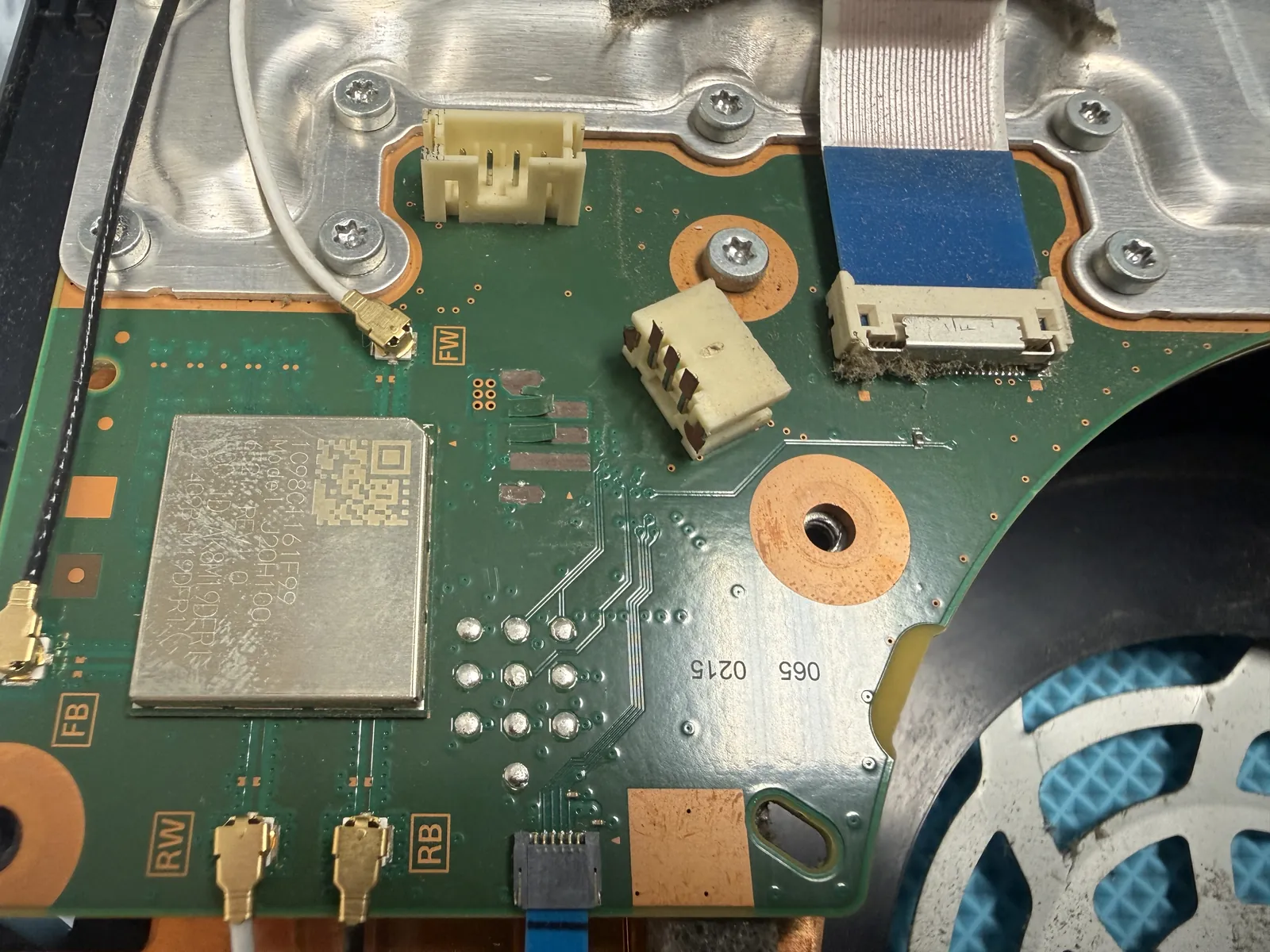 PS5 fan connector torn off the motherboard during a DIY cleaning, lying loose on the board