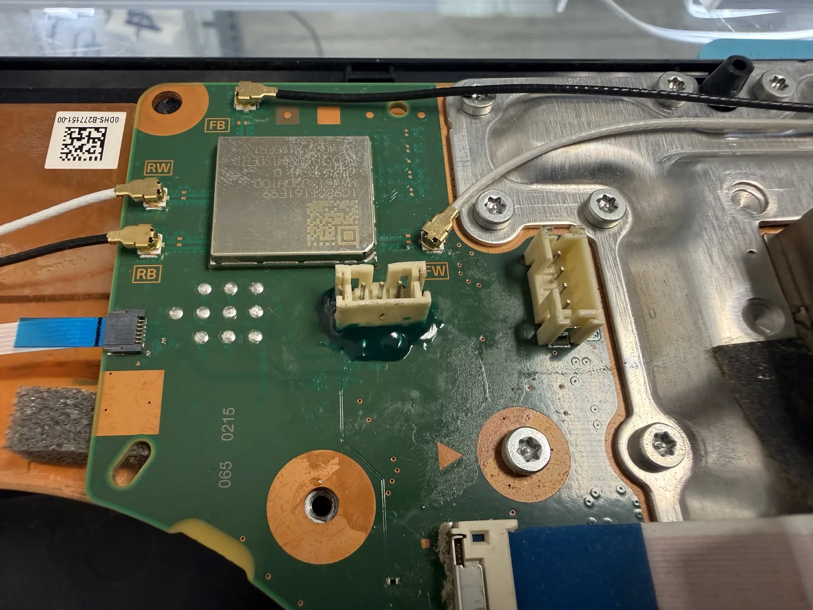 Adhesive and UV resin applied over the resoldered PS5 fan connector to lock it in place