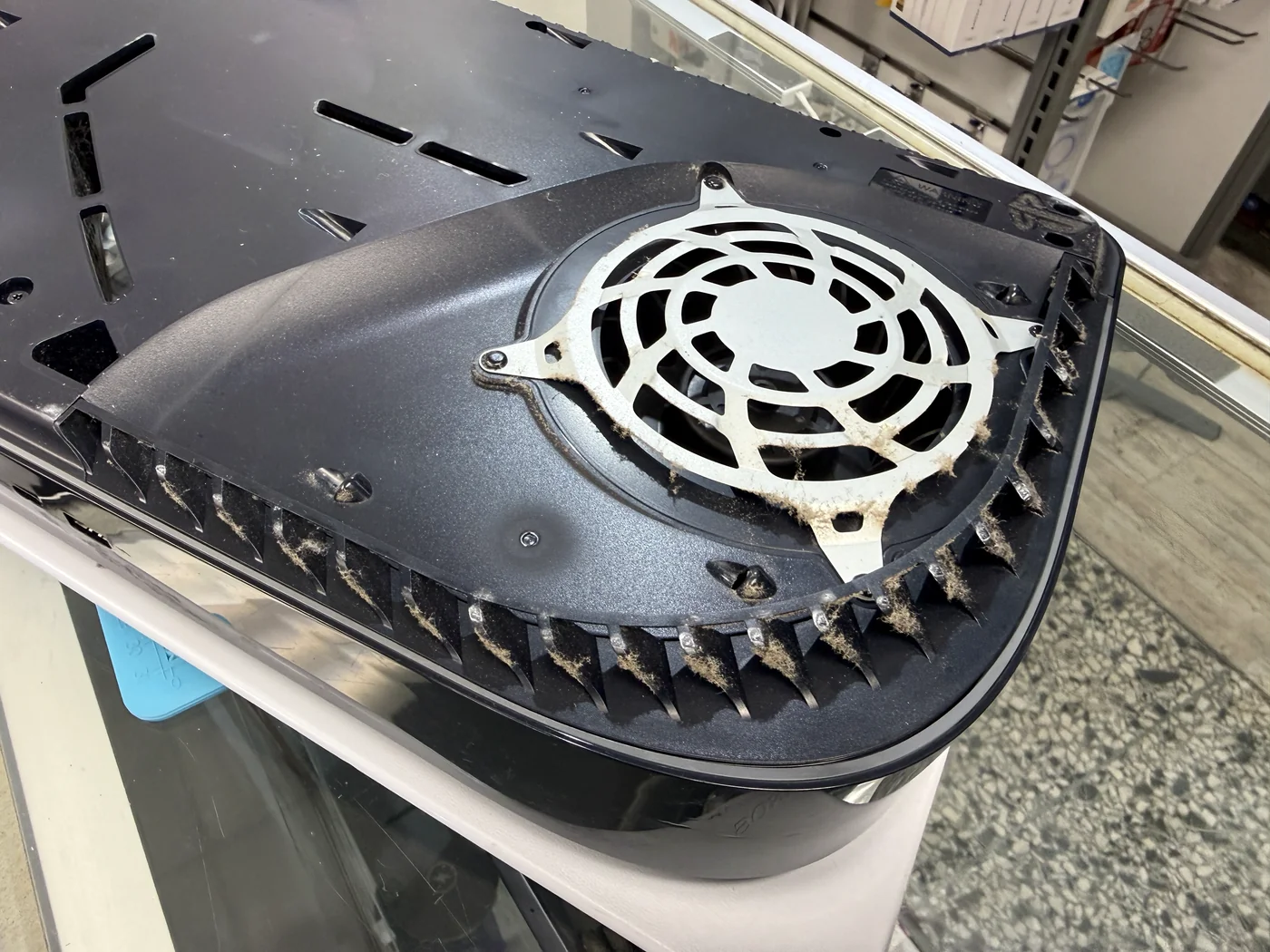 Dust and lint built up on the PS5 fan grille and vents before cleaning
