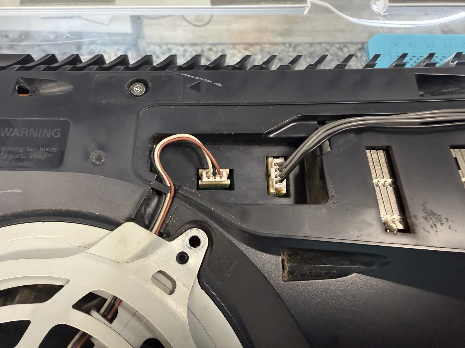 PS5 fan cables plugged back into the repaired connector and running normally