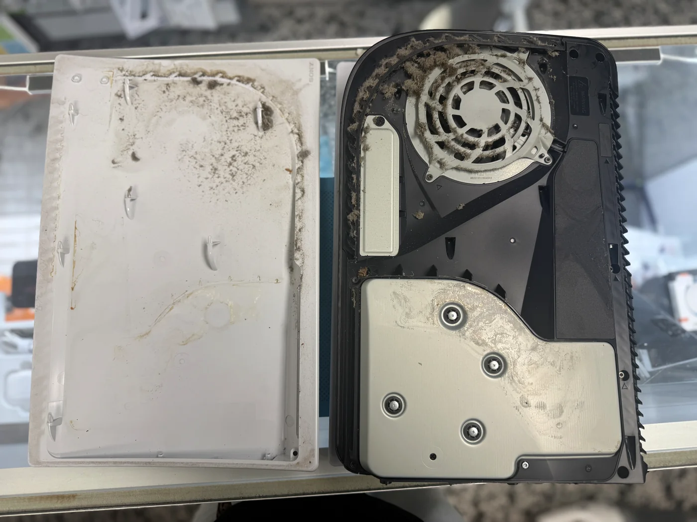 PS5 side panel and cooling fan caked in dust before deep cleaning