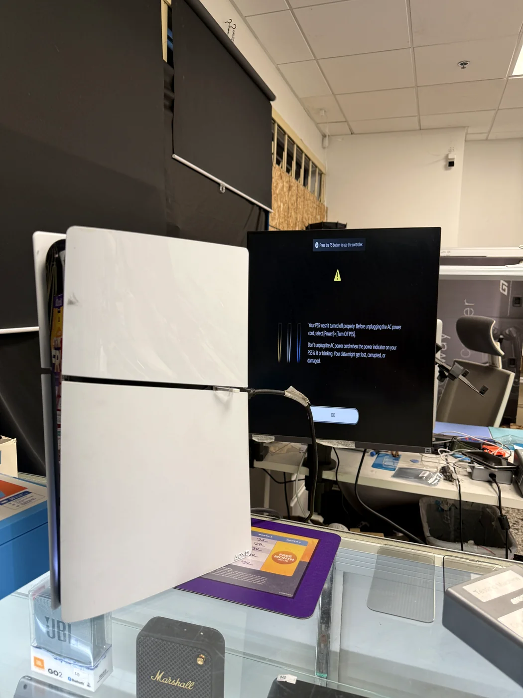 Repaired PS5 Slim booting on the bench monitor after HDMI port replacement, signal restored